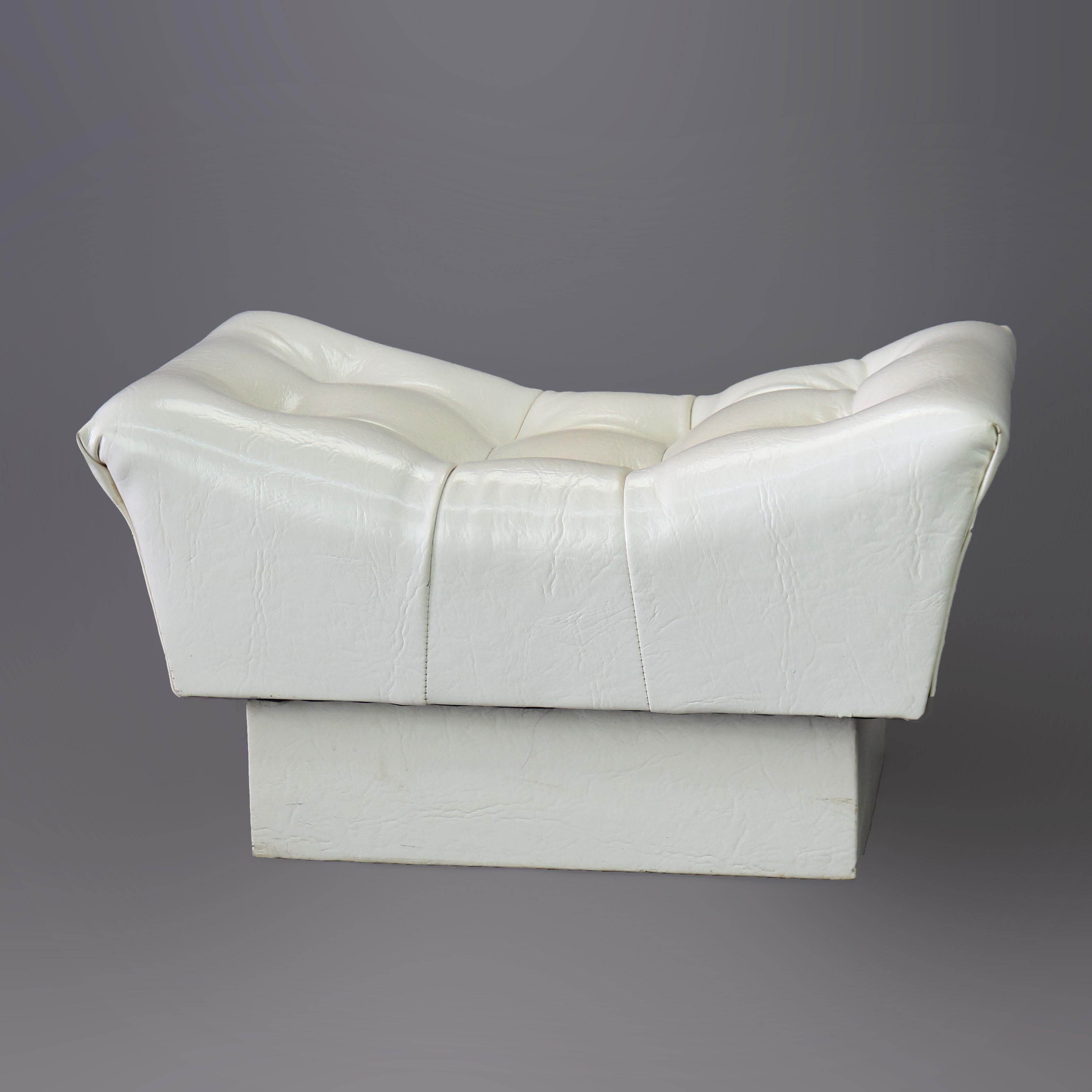 A Mid-Century Modern footstool offers scooped form with tufted white leather upholstery and raised on stepped base, 20th century

Measures- 15.5'' H x 28'' W x 19.75'' D.