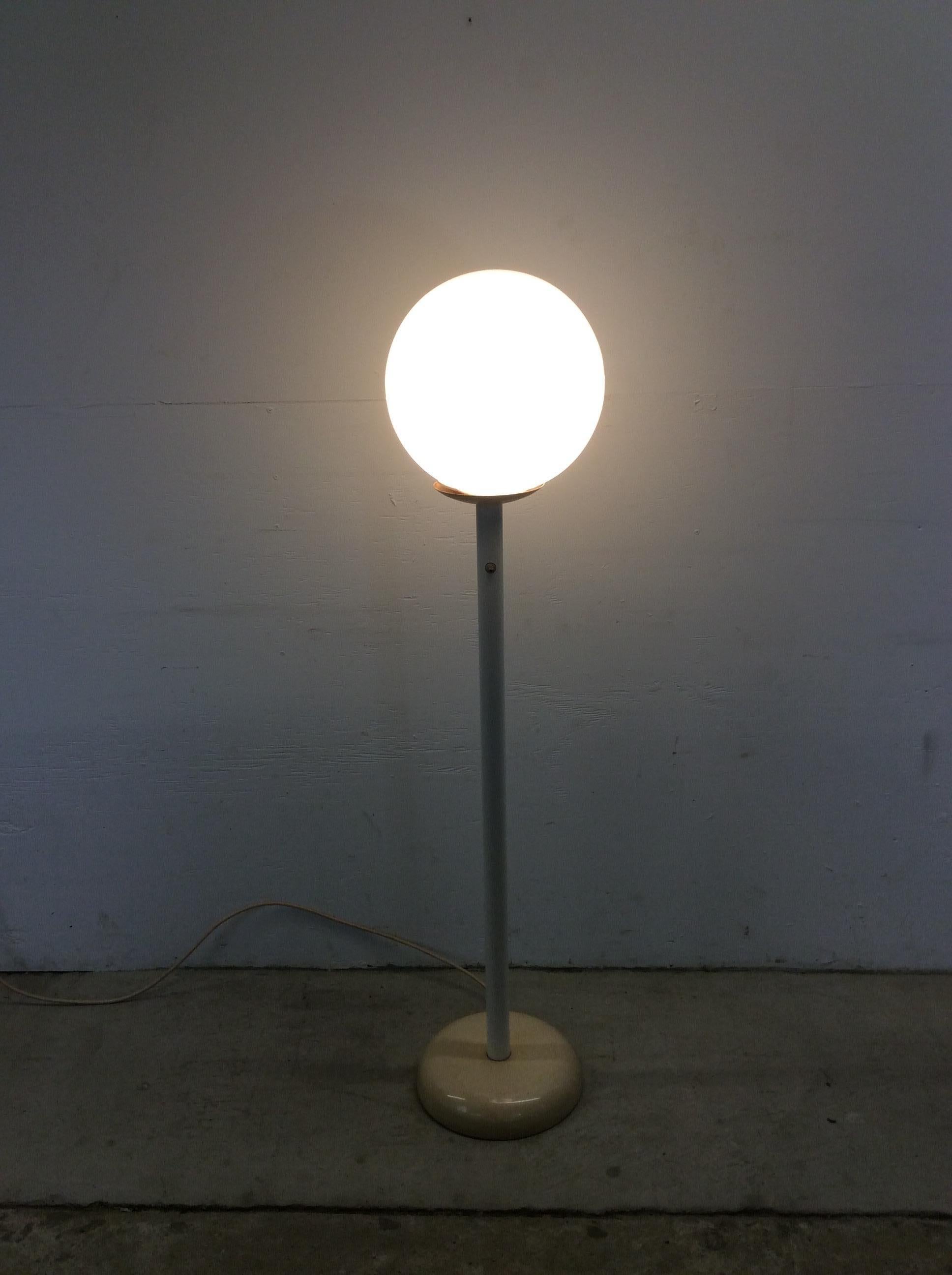 This mid century modern floor lamp features original white painted finish, large white plastic globe, original wiring, and rounded base.

Dimensions: 13w 13d 57h

Original finish is in good condition with only minor scuffs, slight scratches, small