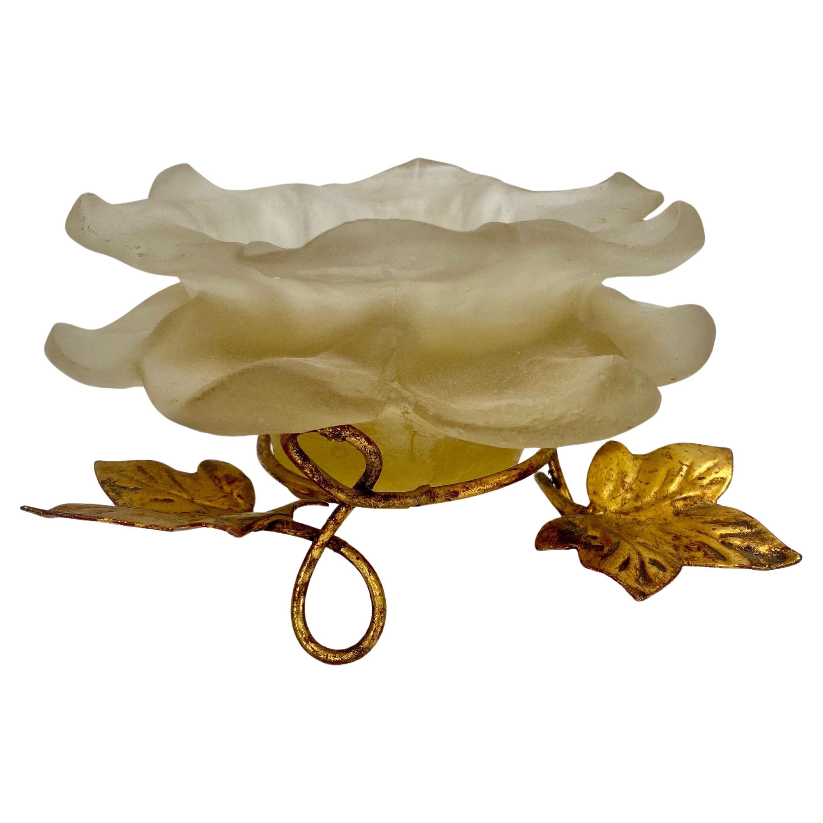 A Mid Century Modern flower shaped candleholder. Made of white frosted lucite, the beautiful flower can holder is raised by a antiqued gold base in the shape of leaves adding charm and elegance to this beautiful home accent piece. 


Dimensions: