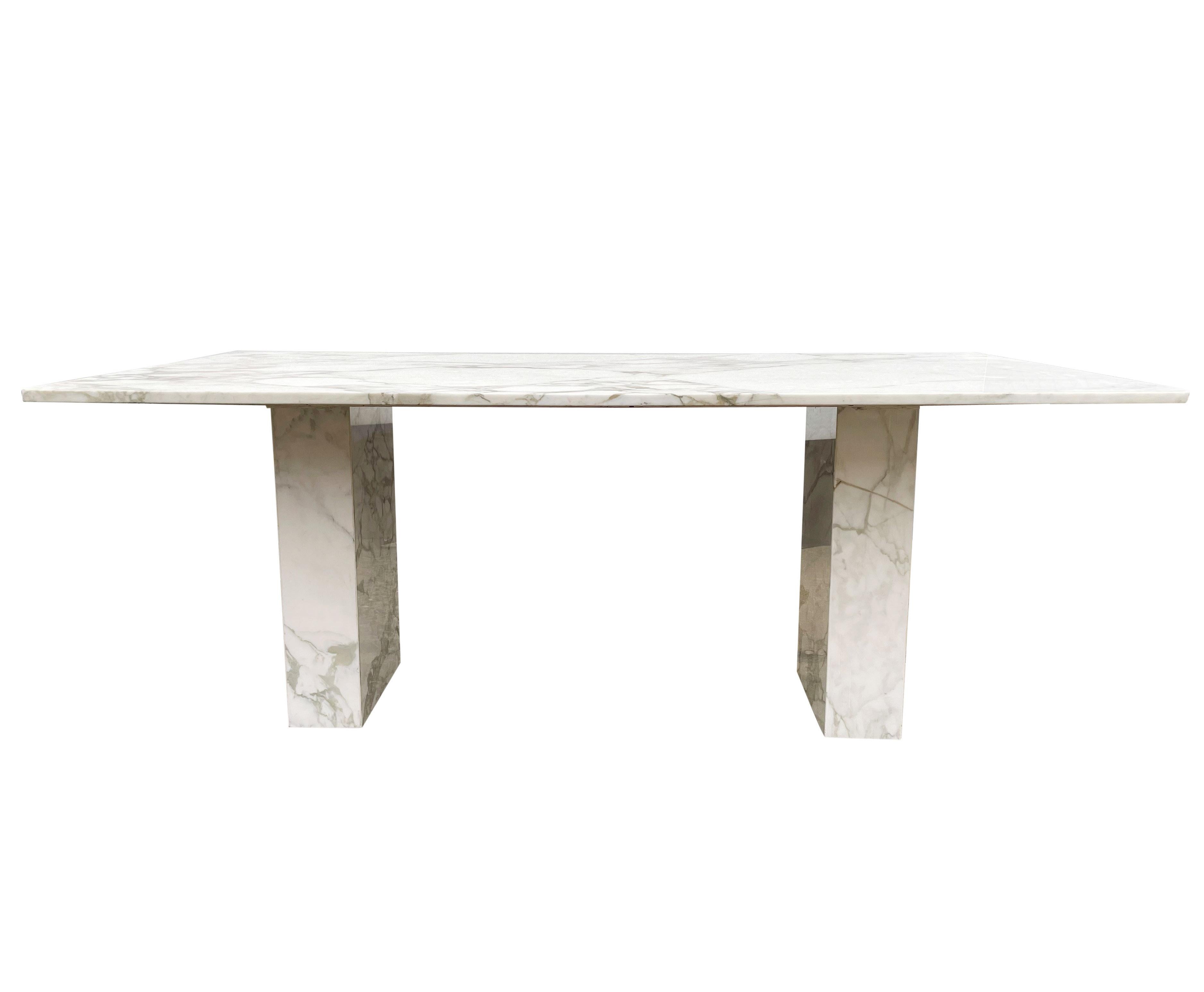 A stunning clean line design imported from Italy, circa 1960s. This dining table consists of calacatta marble slab construction. Beautiful gray and taupe veining on white base color.