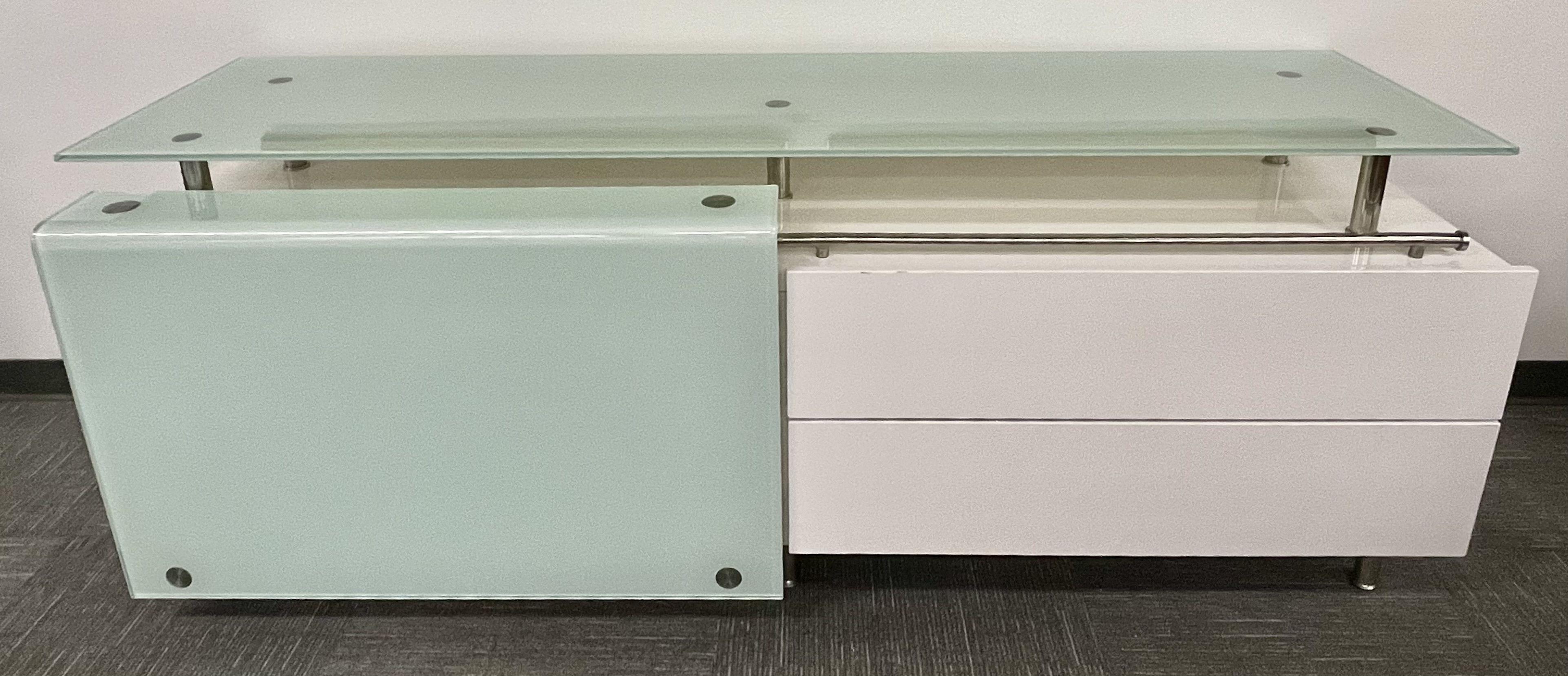 Mid Century Modern White Lacquered and Glass Console, Dresser or Sideboard
This unique and rare sideboard cabinet or dresser is simply stunning. Recently refinished in a white lacquer having two drawers on the right hand side with hidden shelved