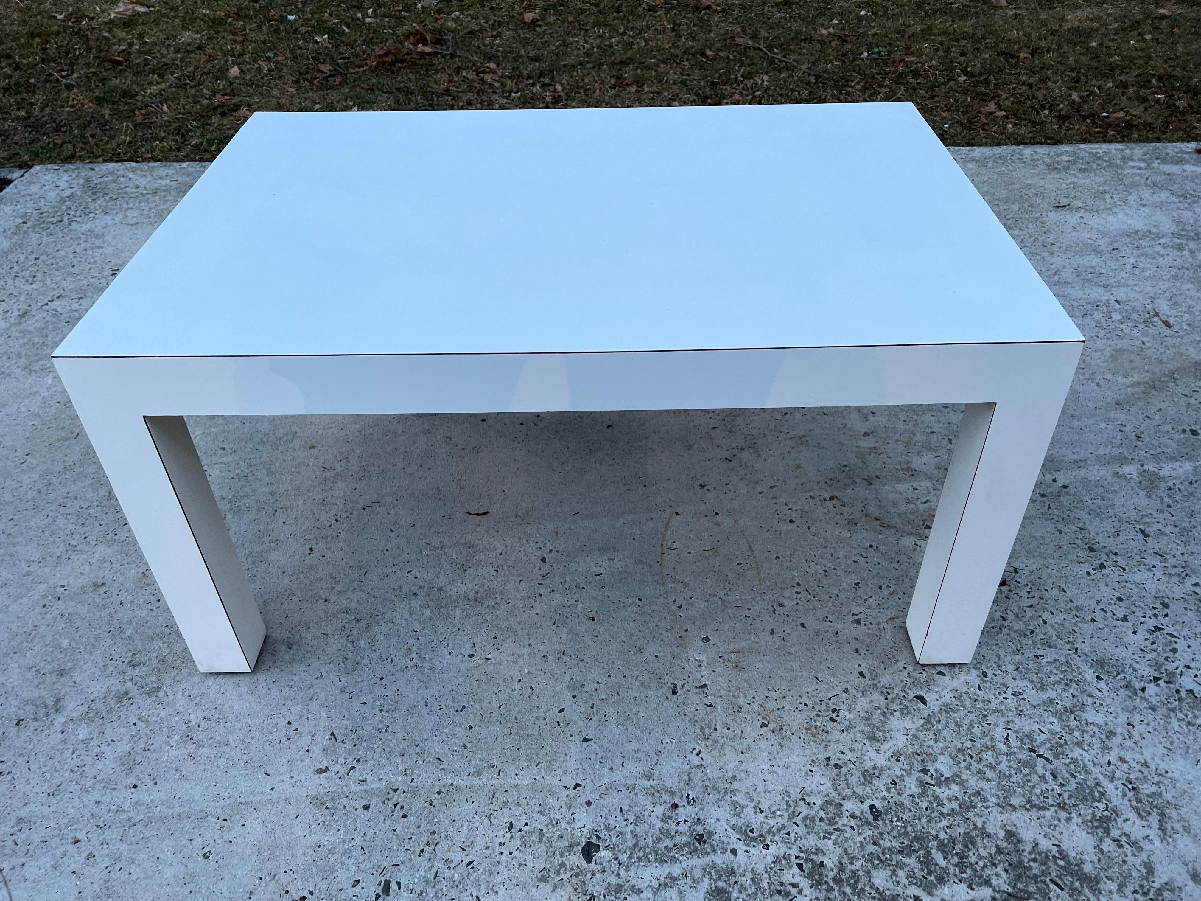 Mid-Century Modern white laminate parsons table. Sleek modern design, quality white laminate exterior over plywood base. Perfect for that post modern minimalist design.
 