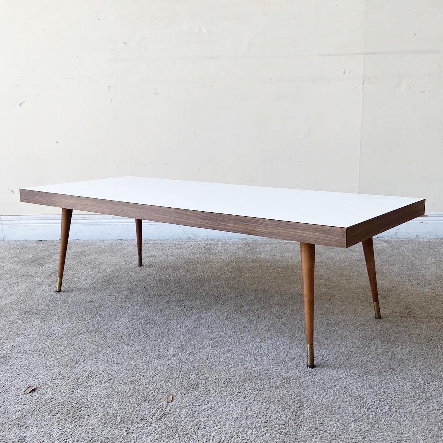 Exceptional Mid-Century Modern coffee table. Features a wooden frame with a white laminate top.
 
