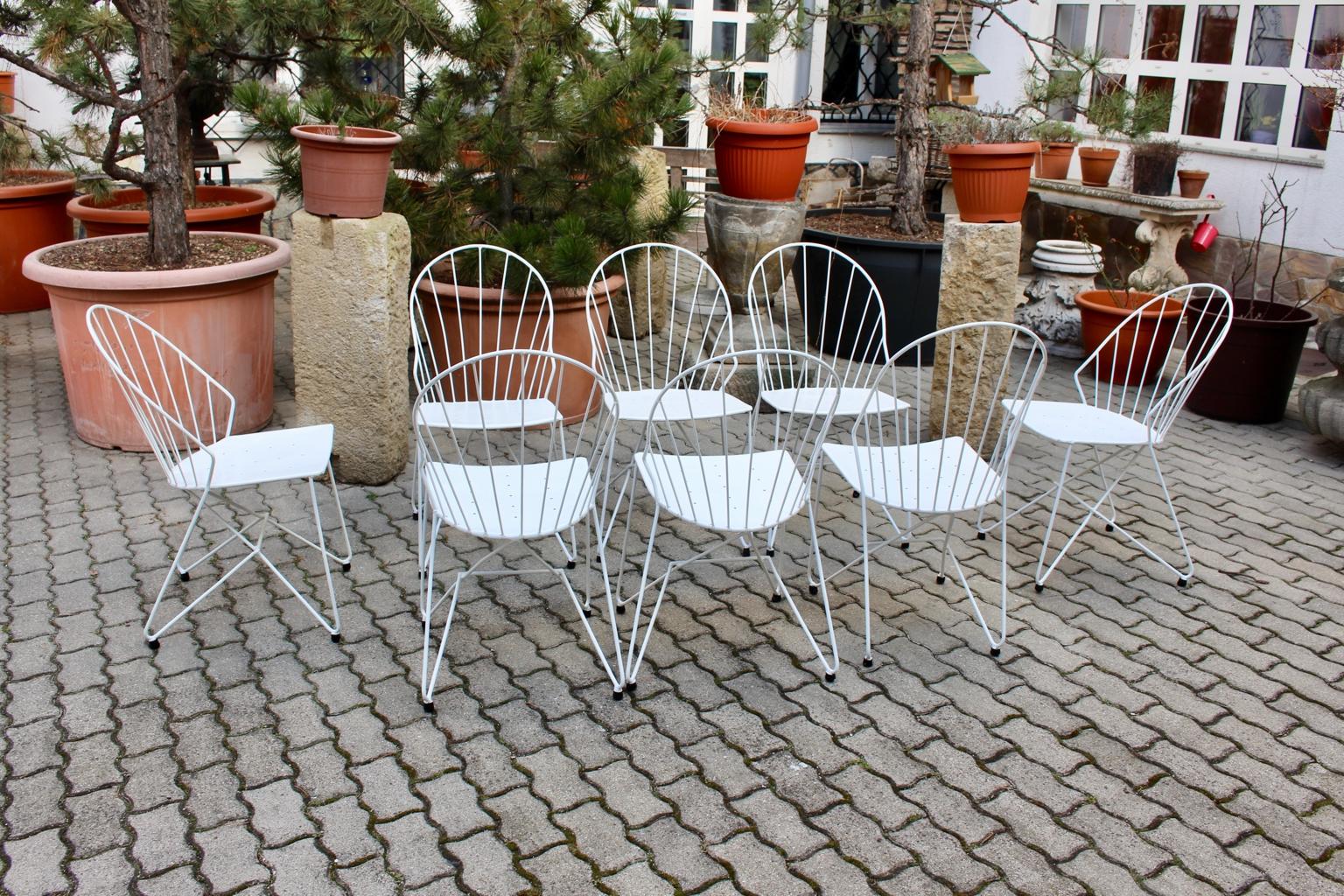 Mid Century Modern set of 8 white elegant metal armchairs designed by J.O.Wladar & V. Mödlhammer Vienna circa 1955 for Sonett Karl Fostel´s Sen. Erben.
Also the garden chairs were made of wire steel and perforated sheet metal with black rubber