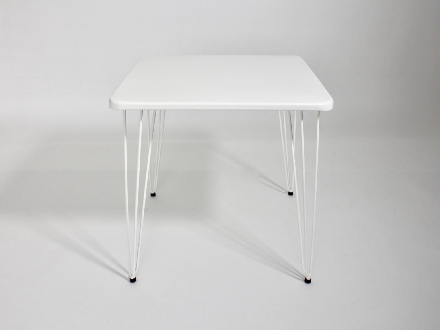 This presented squared white metal vintage table was designed by J.O.Wladar & V. Mödlhammer, Vienna, circa 1955 for Sonett Karl Fostel´s Sen. Erben.
Also the table was made of wire steel and sheetmetal. Additionally the table is carefully cleaned