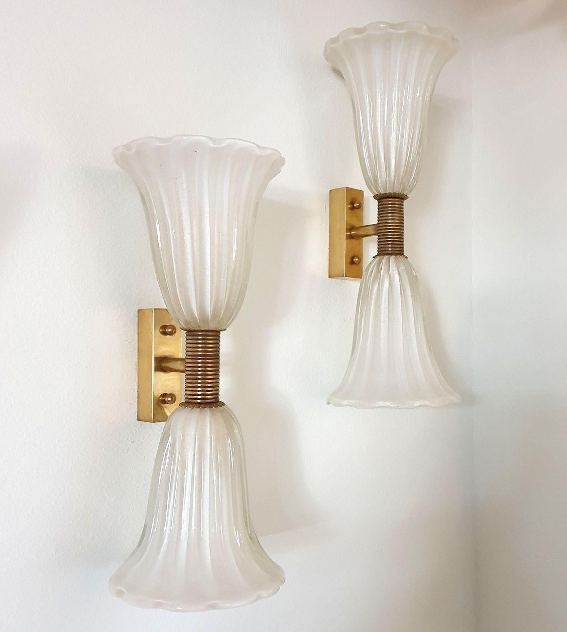 Pair of Mid-Century Modern white Murano glass & brass sconces by Barovier and Toso, Italy 1960s.
The vintage sconces have 2 corolla shades each; with one light in each, one light up, one light down.
Rewired for the US.
The Murano glass is hand