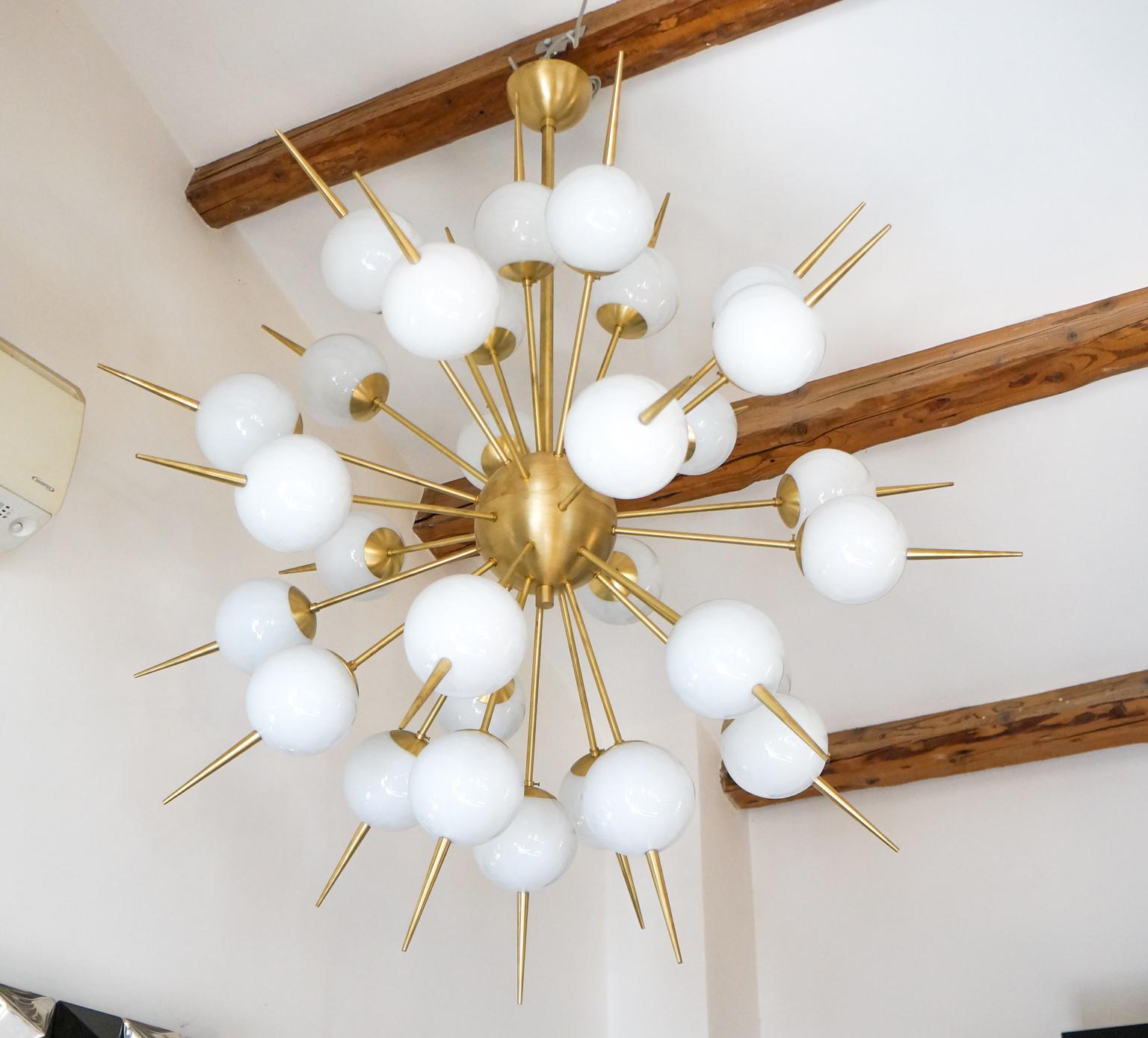 Fantastic chandelier in blown Murano glass with 30 elements white satin color and Sputnik in satin brass.
This chandelier is a project of the Murano glass master Alberto Donà in 1980s
Chandelier can be re wired for your country code.
Replacement