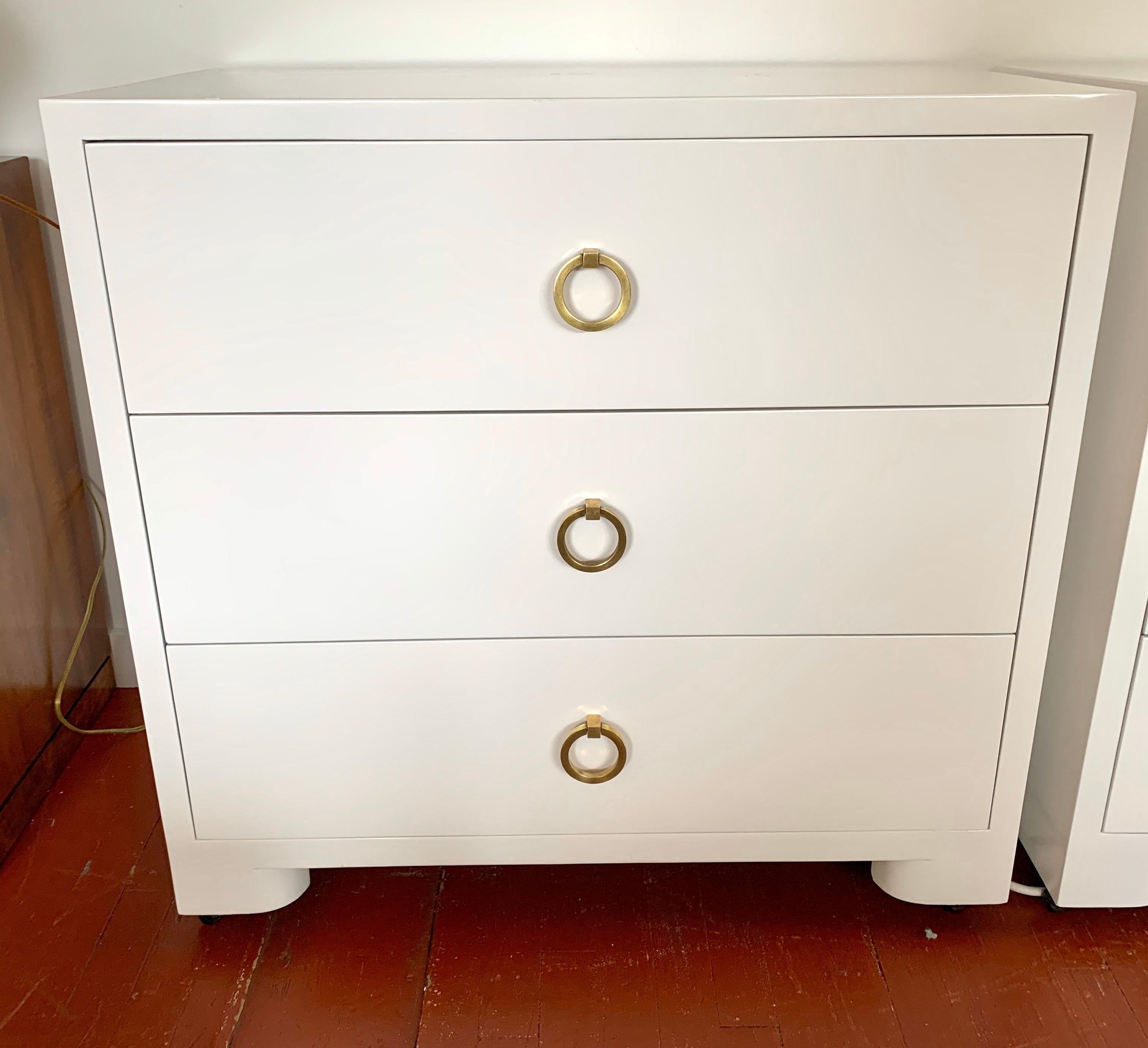 Elegant newly lacquered small chest on casters for ease of movement. True period piece that has been newly lacquered in white and has original brass hardware.