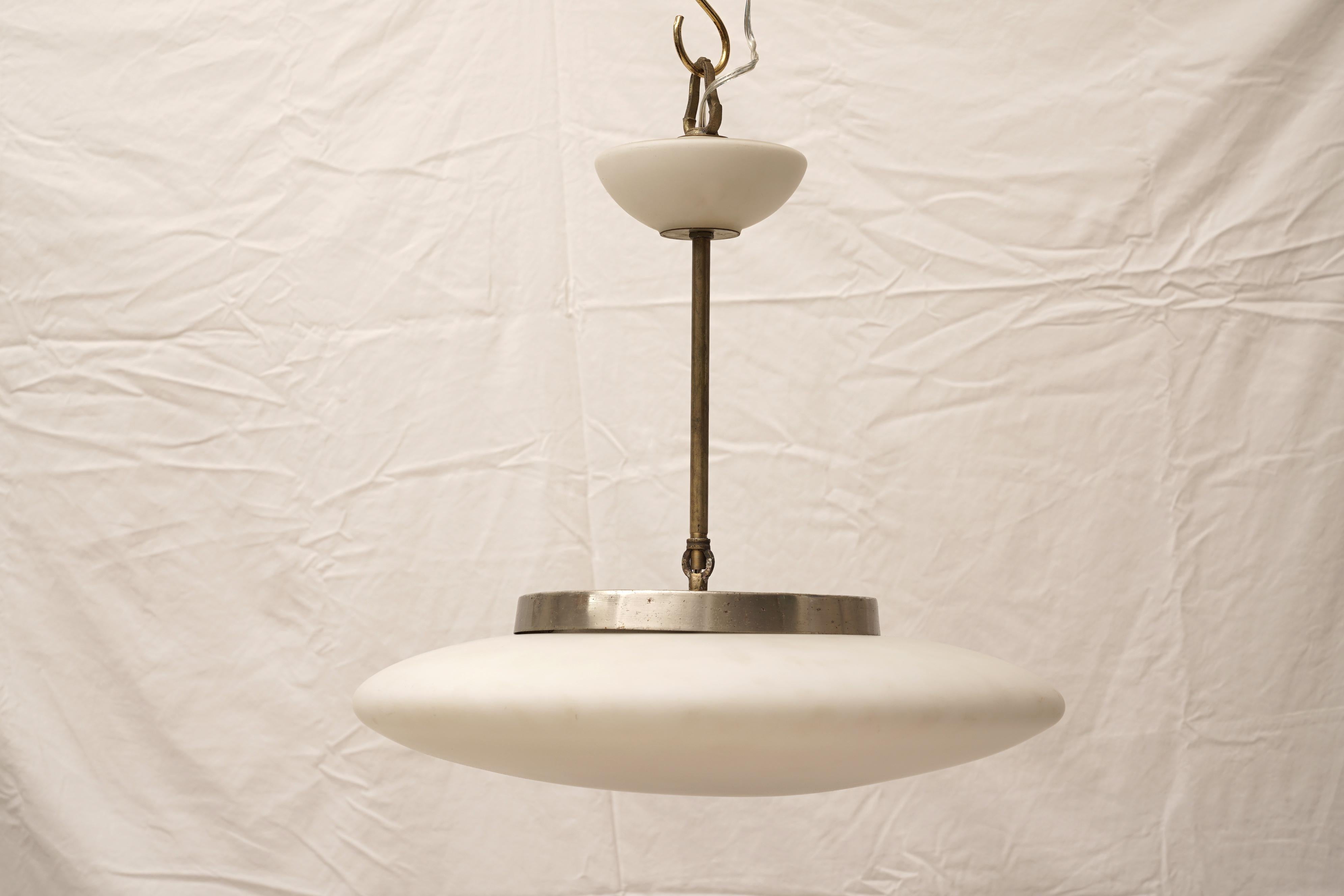 A great, sculptural form, this saucer-shaped, white opaque glass ceiling pendant. Complete with matching glass ceiling canopy. Mid-Century Modern, European. Rewired for American use. If you need additional length, I can supply brass or chrome chain