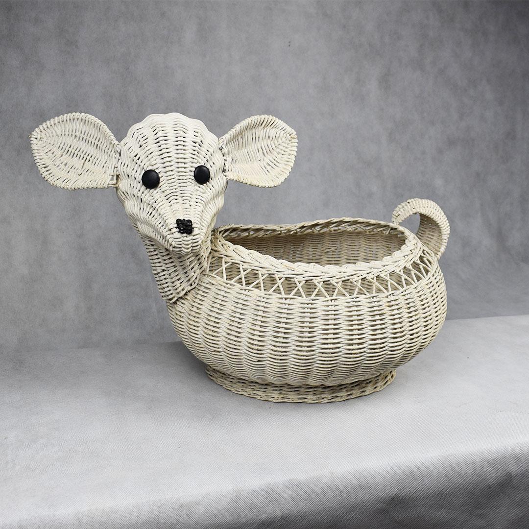 White baby lamb animal wicker rattan woven basket. A great piece for storage in a children's room, this whimsical woven rattan piece features two ears that stick out to the sides of the head. The body and head are woven in a basketweave pattern. A
