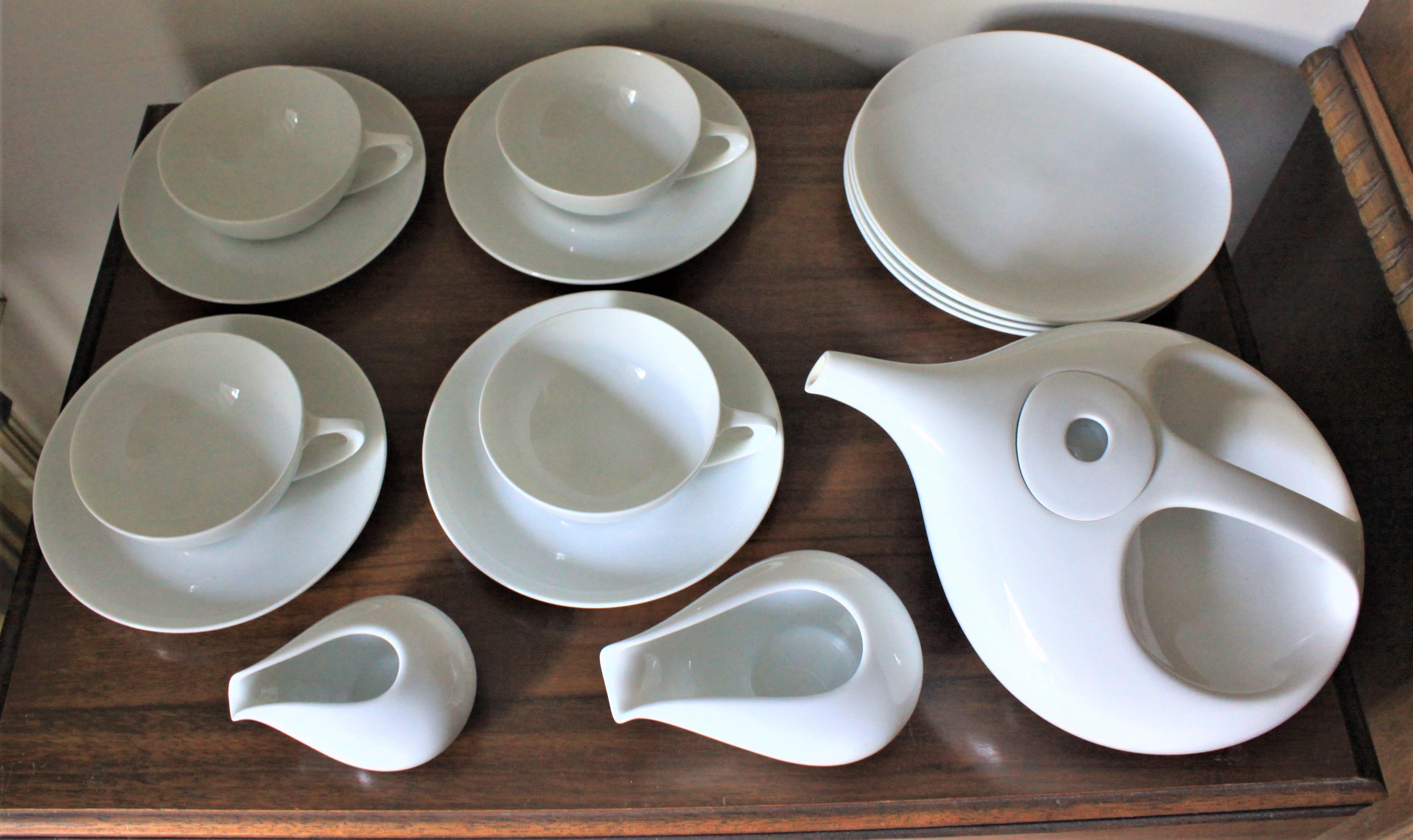 This signed Rosenthal Germany tea or luncheon set was done in white porcelain in the period and style of midcentury modernism. The set includes four tea cups and saucers, four dinner sized plates, a large tea pot and matching cream and sugar bowls.