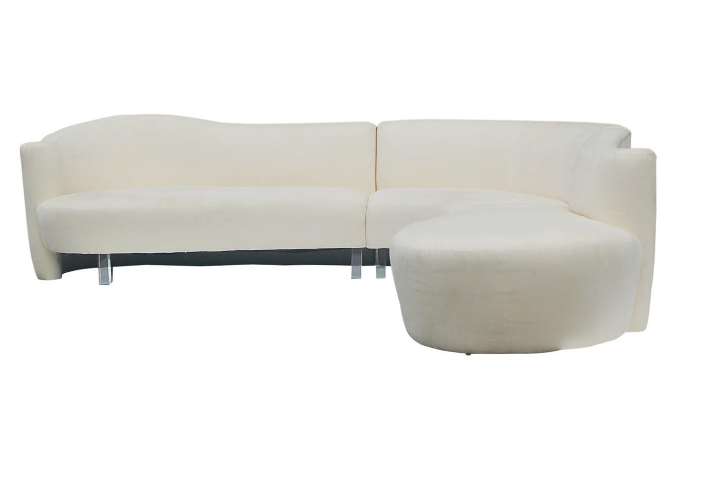 An impressive sculptural design by Weiman Furniture in the 1980s. This sofa features 3 piece locking sections, Lucite legs, and white upholstery. Manufacturers label. The upholstery is original and is slightly soiled. Cleaning or reupholstery is