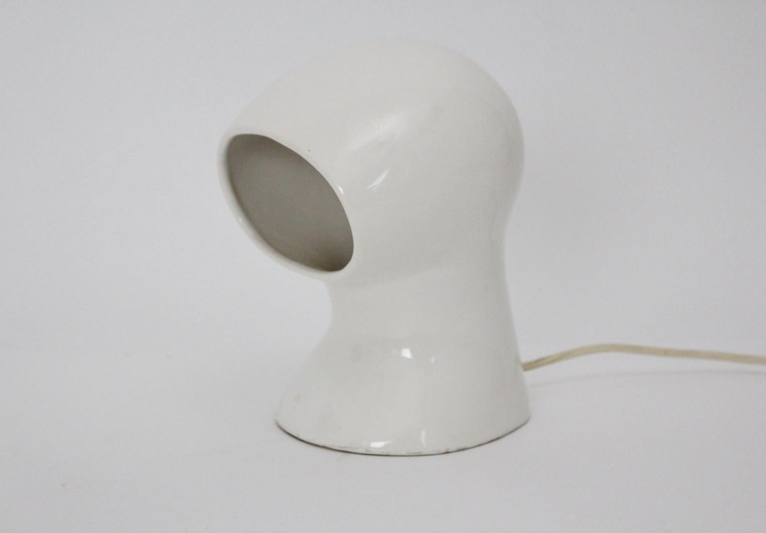 Space Age 20th century table lamp from ceramic in white color 1960s.
Wonderful ceramic table lamp with a glossy surface, which set apart from other Space Age table lamps through its tranquil and sleek appearance.
One E 27 socket.
The vintage