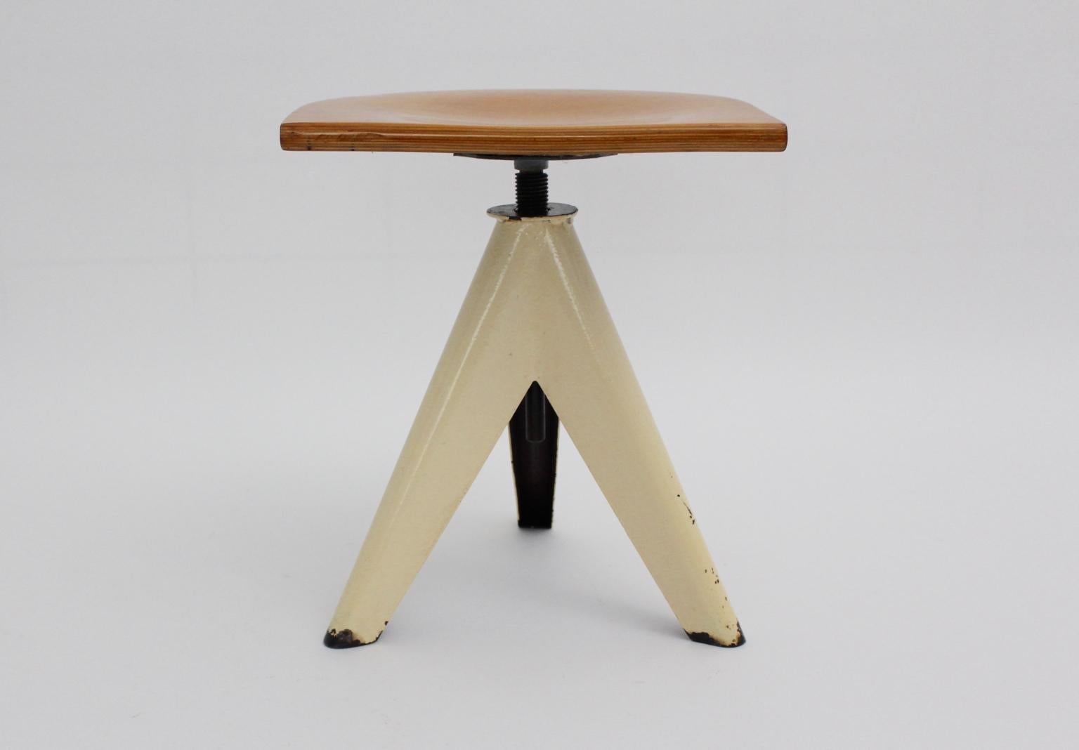 This presented vintage metal tripod industry stool is height - adjustable from 43 cm to 47 cm.
Also the steel base is ivory lacquered and shows beloved signs of age and use.
The swivelling seat was made of solid natural lacquered beechwood.
approx.