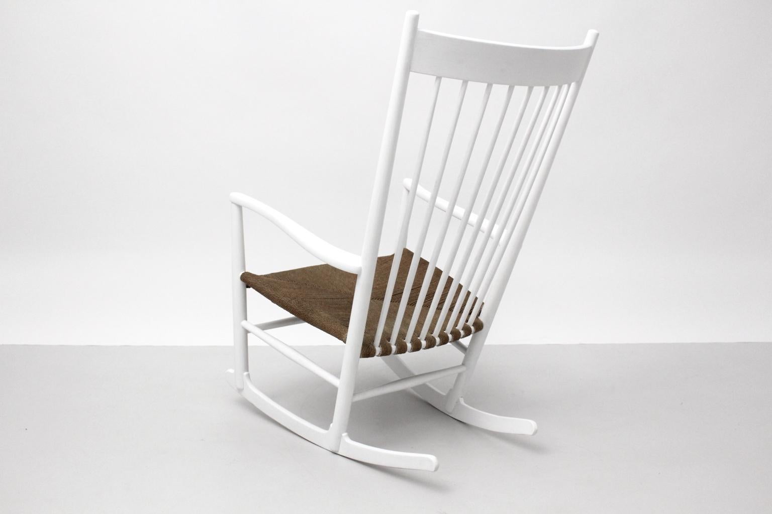 Scandinavian Modern Classic rocking chair J 16 by Hans Wegner designed 1944 and executed by Mobler F.D.B., Denmark, 1964 - marked.
The lacquered surface was refreshed few years ago. The seat shows a string mesh.
The vintage condition is very good