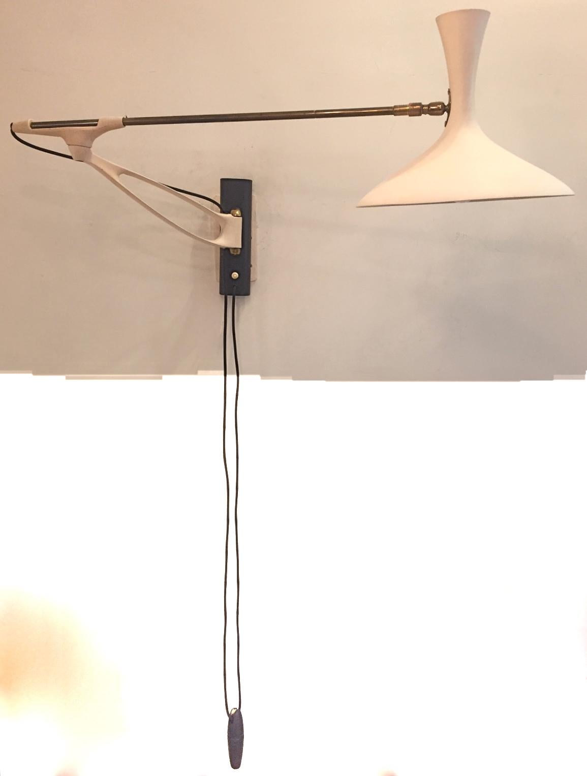 An extendable metal wall lamp attributed to Louis Kalff. Rewired for USA. Excellent condition.
 