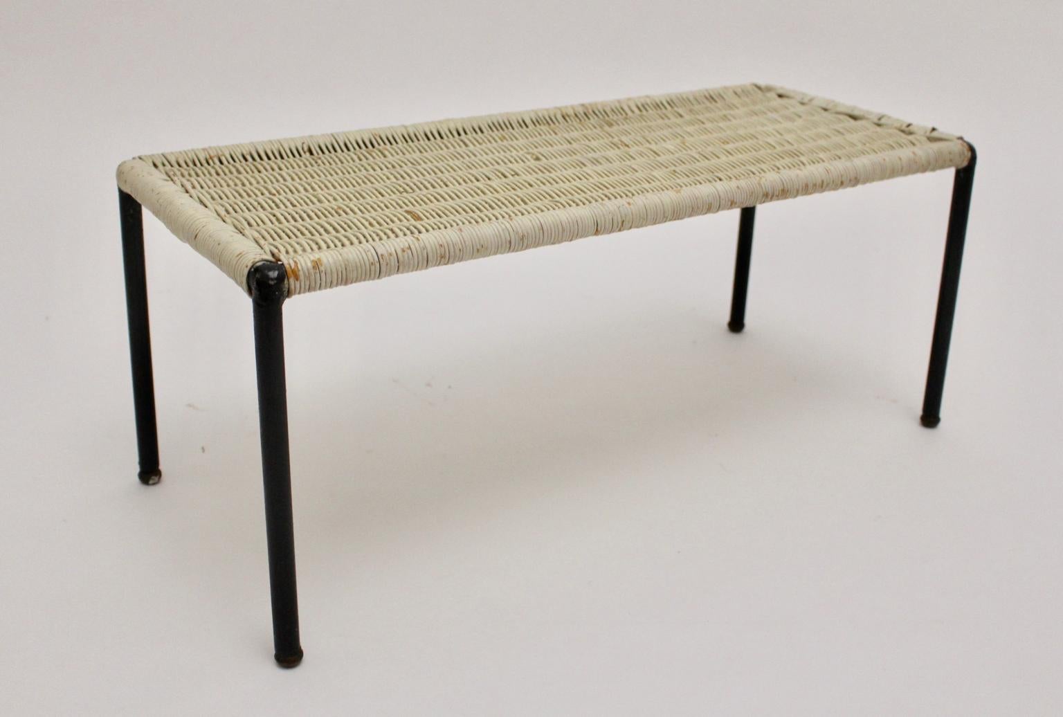 We present a white lacquered wicker side table with black tube steel frame, Austria 1950s.
The wickerwork is in very good vintage condition with some signs of age, just as the black lacquered tubular steel frame.
approx. measures:
Width: 66.5