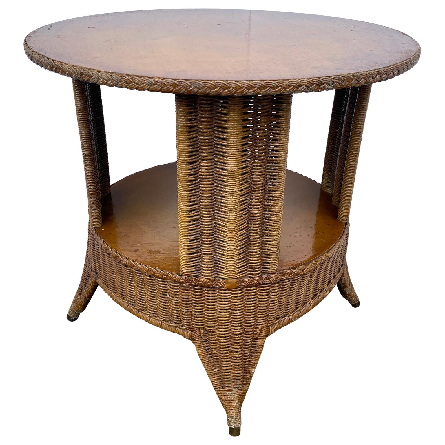 Mid-Century Modern wicker and wood two-tier round end table. Vintage round table is sturdy and an excellent choice for anchoring a large sofa or between two chairs. With it's height it can also be used as a cocktail table or foyer piece. The table