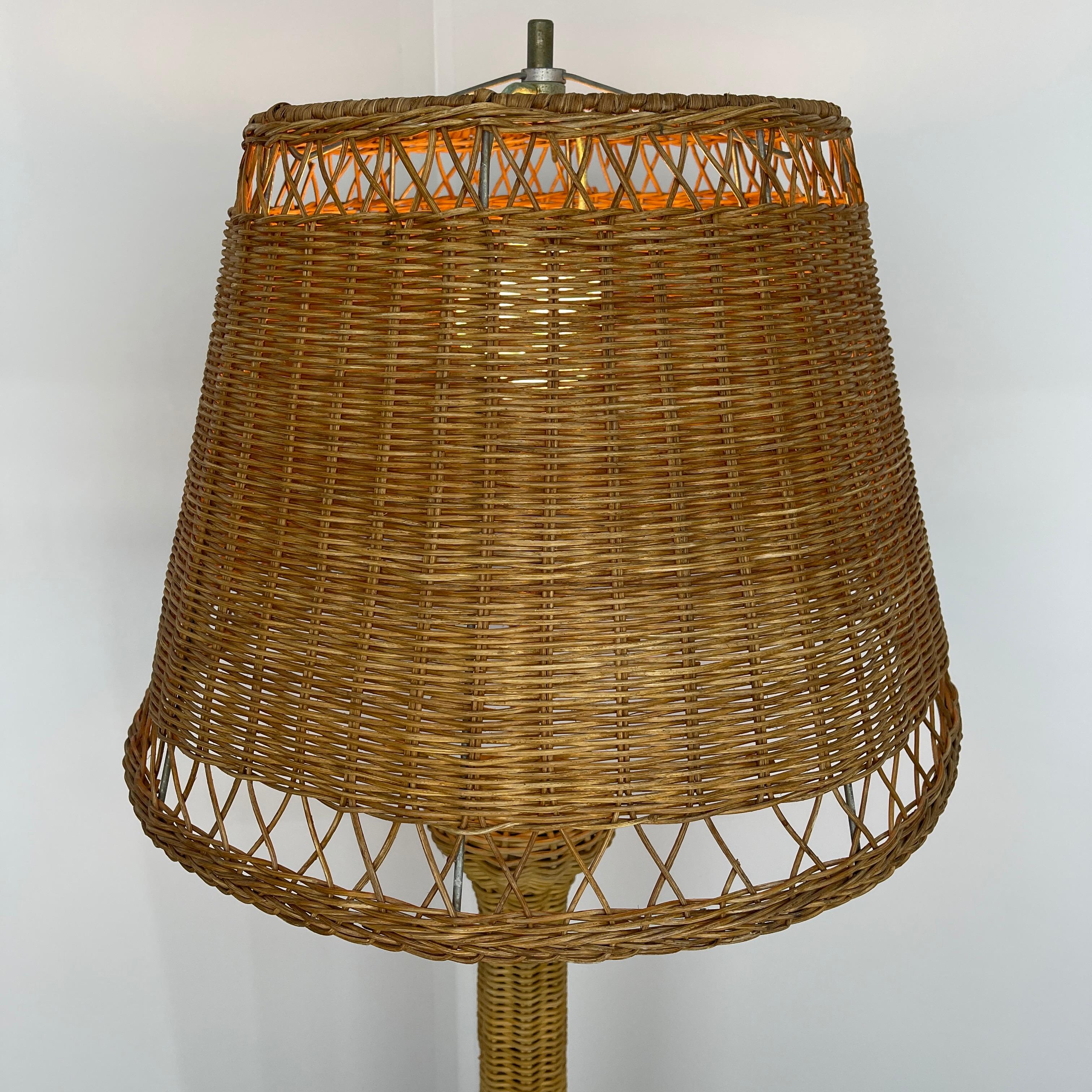 Tall wicker floor lamp with woven wicker shade. This iconic Mid-Century Modern lamp is perfect for the vintage styled room as well as a patio or porch. The light glows through the wicker shade making the lamp perfect for mood lighting in any room.