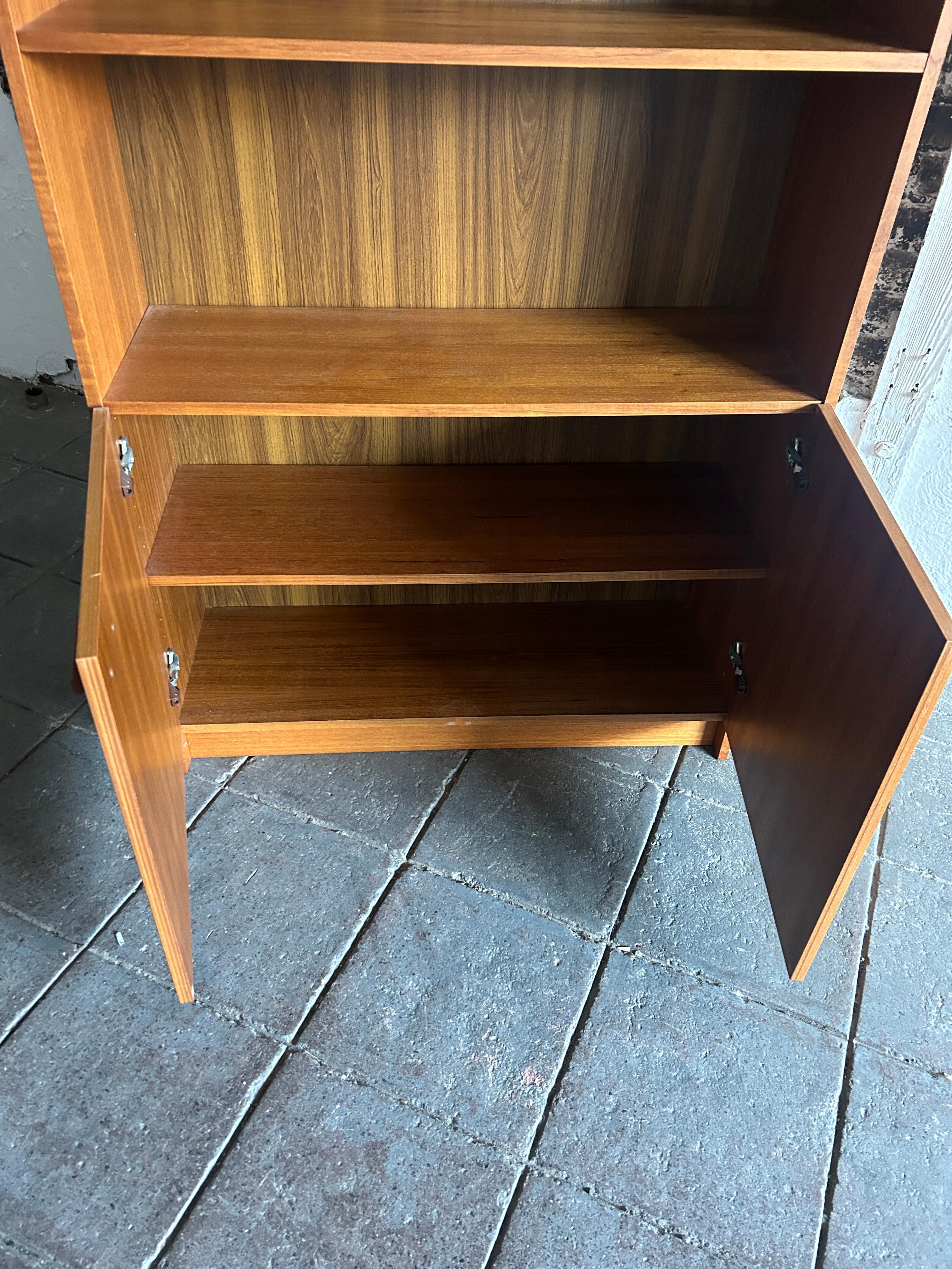 Mid-Century Modern wide teak tall bookcase (2) cabinet doors Made in Denmark  In Good Condition For Sale In BROOKLYN, NY