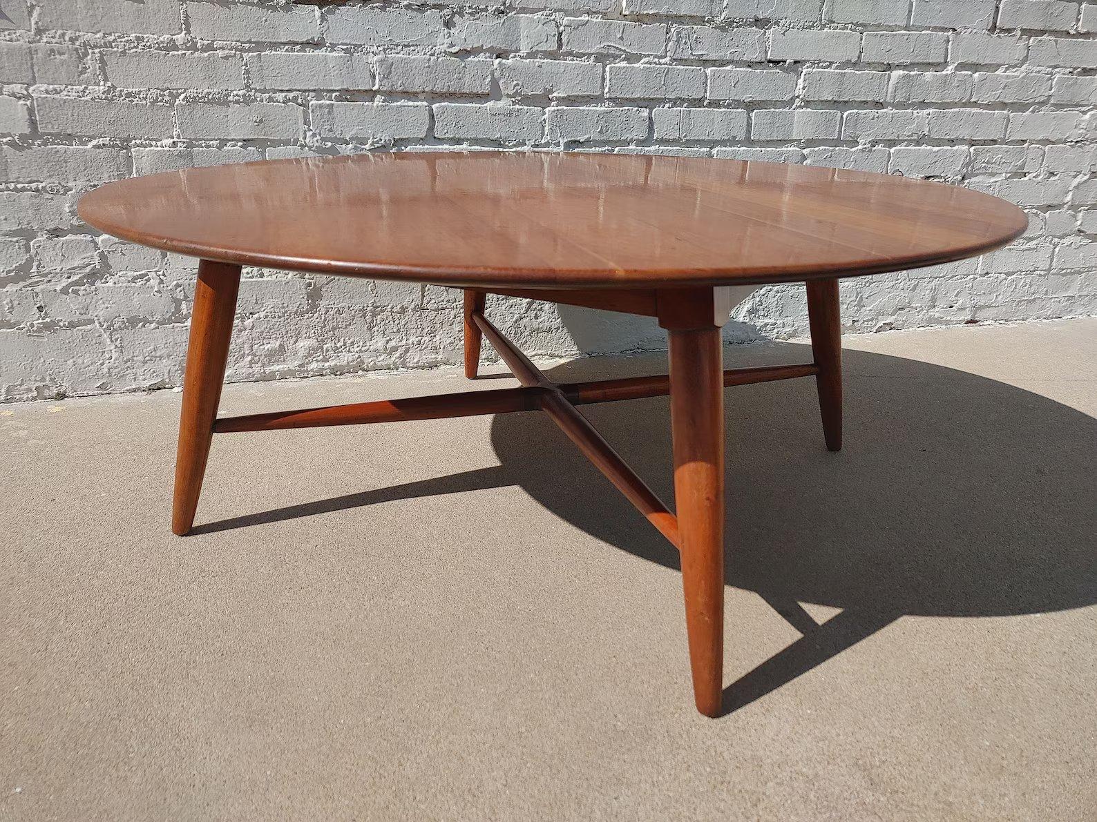 Mid Century Modern Willett Solid Cherry Coffee Table

Above average vintage condition and structurally sound. Has some expected slight finish wear and scratching. Has some small dings on edges and finish wear. Outdoor listing pictures might appear