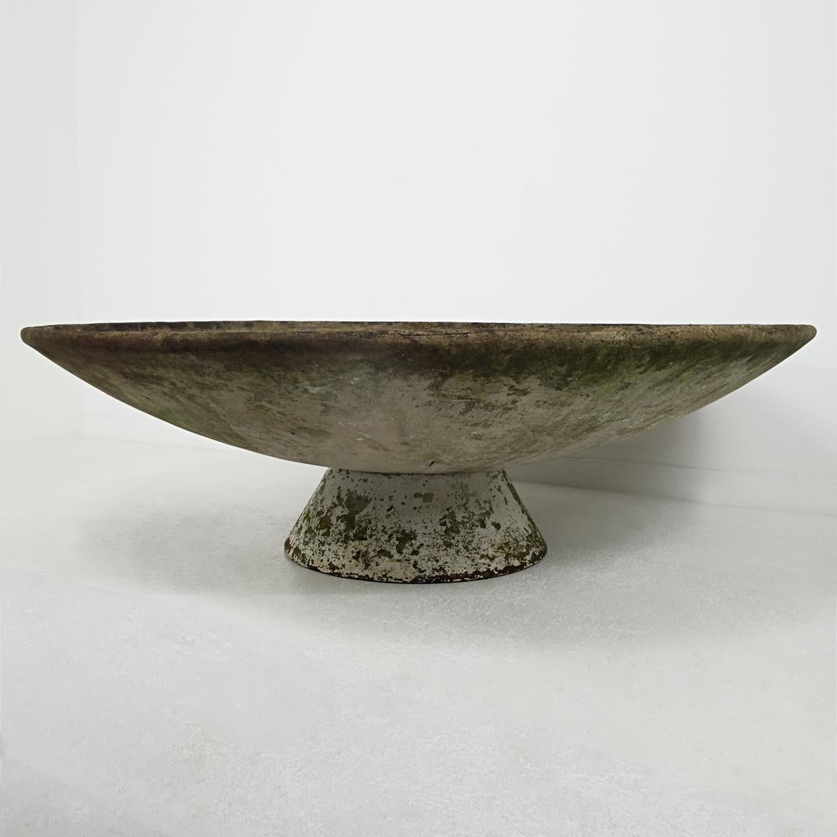 This planter designed by Swiss architect Willy Guhl and manufacturer by Eternit truly is a statement piece with its diameter of nearly 60 inches (150 cm). It has great patina as well

It sits on an independent stand allowing it for a horizontal