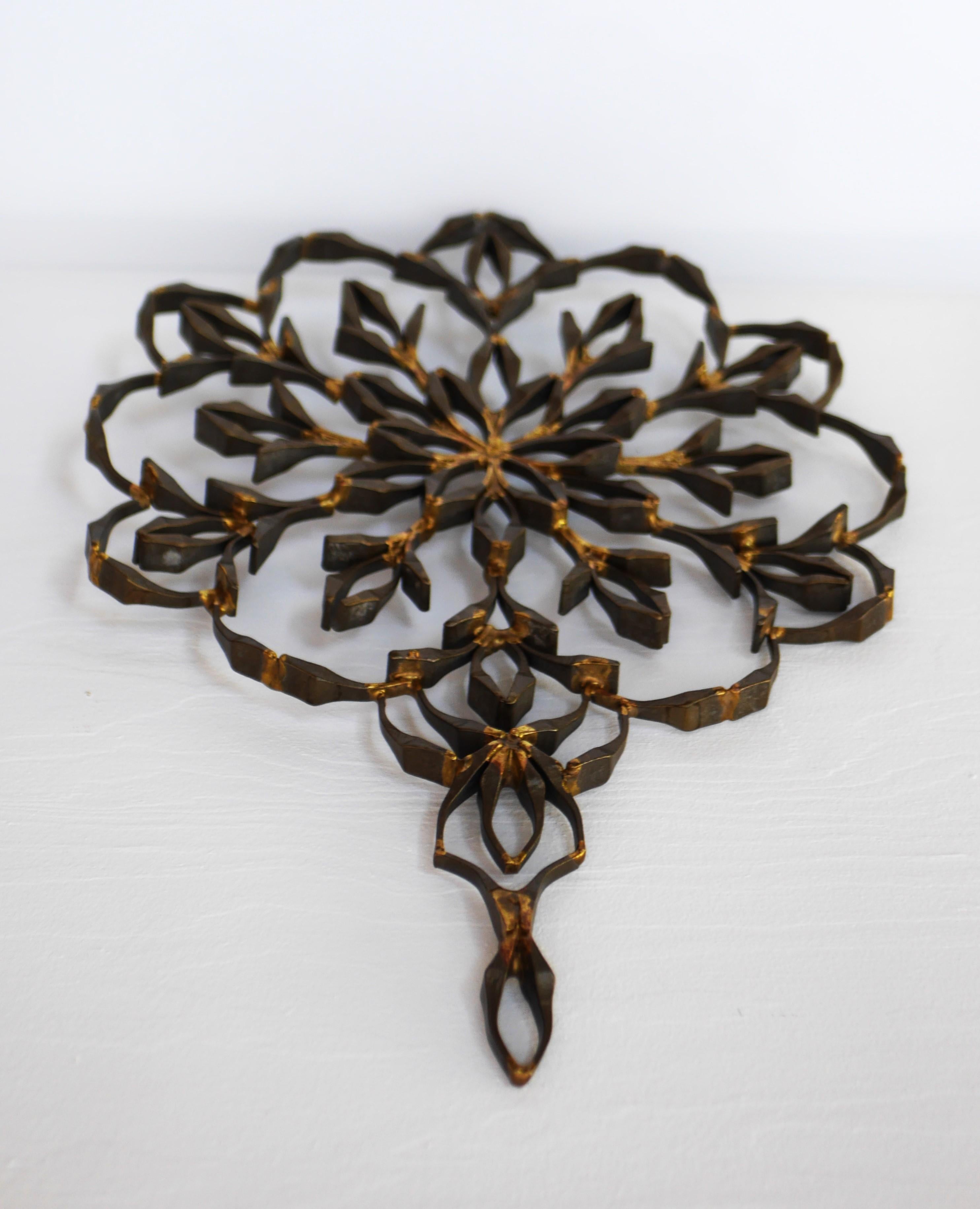 Un pezzo d'arte vintage in metallo a forma di mandala, unico e piuttosto grande. Si tratta di un bellissimo appendiabiti o mobile da parete, che farà un figurone in una stanza o in una finestra. Ha un'atmosfera molto moderna e di metà secolo, ma