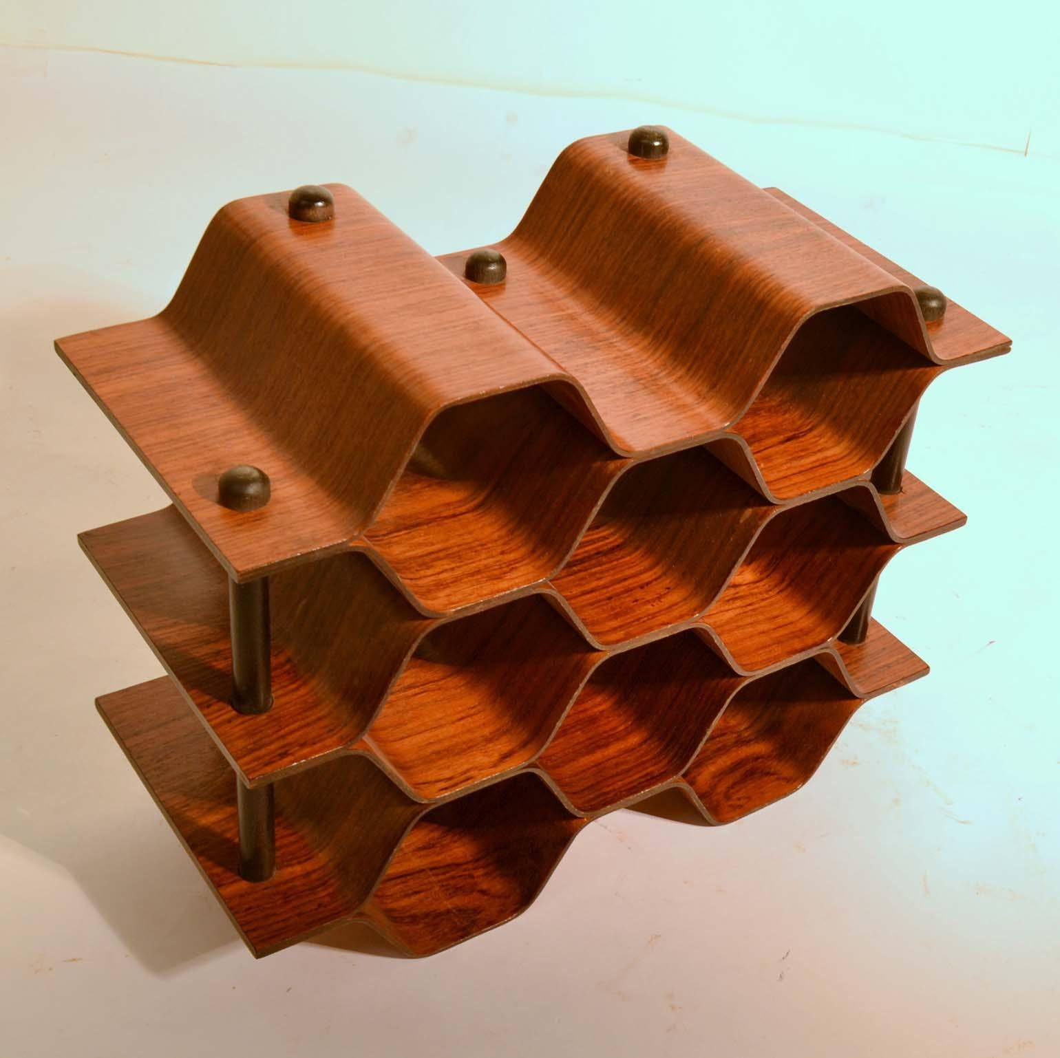 Sculptural wine rack / bottle stand designed by Torsten Johansson. Produced by AB Formträ in Sweden in the shape of a honeycomb, holding up to eight wine bottles. The rack is made of bent ply palisander with black vertical supports. This highly
