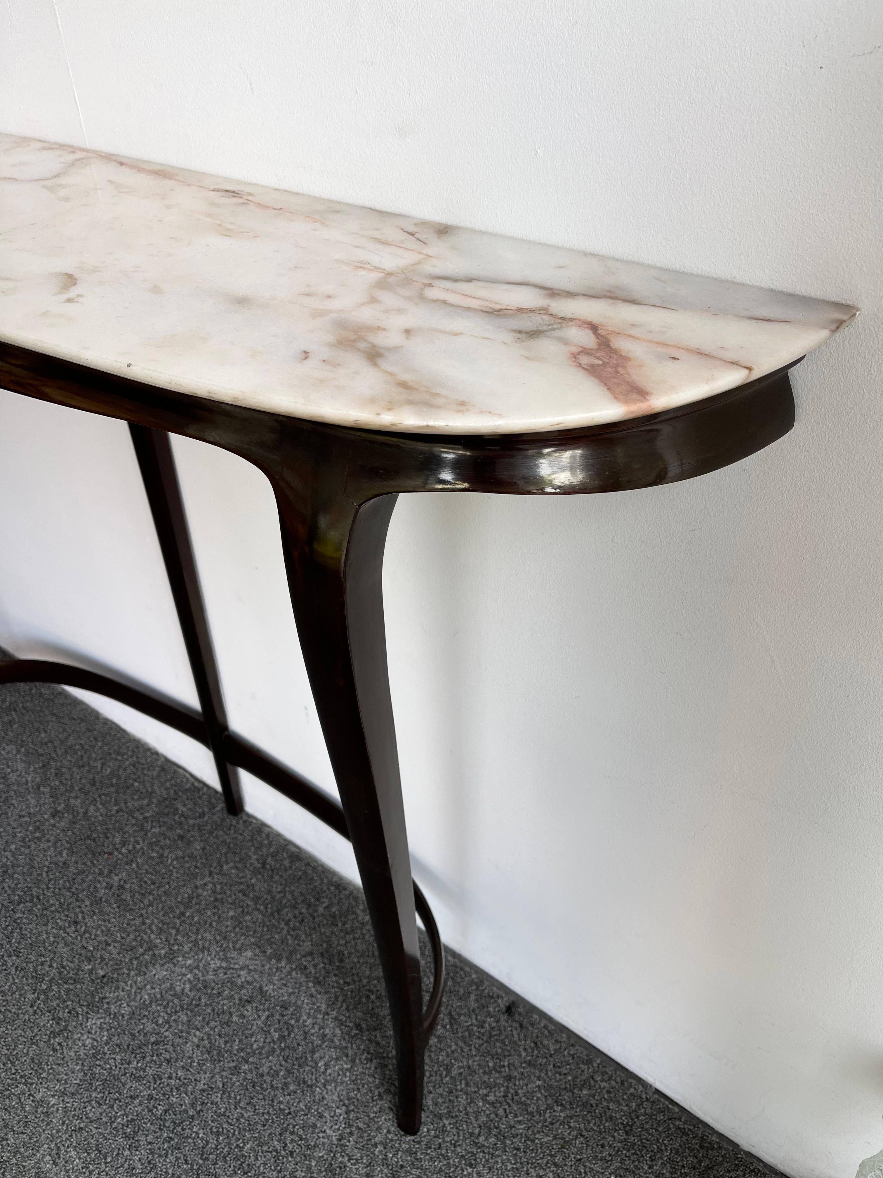 Rare Mid-Century Modern console table in wood and marble by the italian design manufacture La Permanente Mobili Cantù, design attributed to designer Gio Ponti due to his long collaboration with the manufacture during the 1950s, 1960s. Famous design