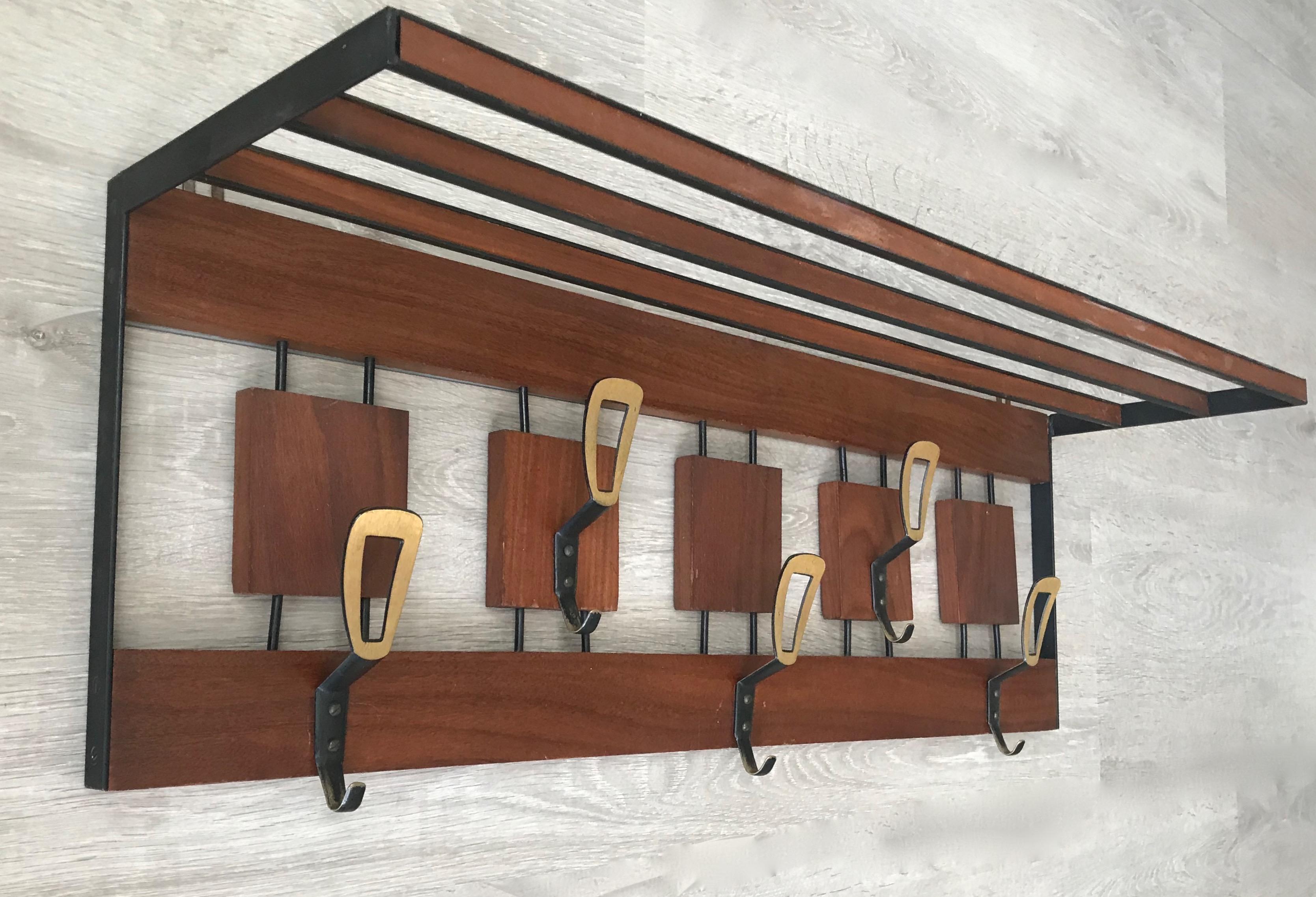 Rare and stylish Mid-Century Modern coat rack.

For the collectors of rare, European midcentury furniture we also have this designers wall coat rack by Hertha Baller. Its symmetrical and open design combined with the marvellous colors of the quality