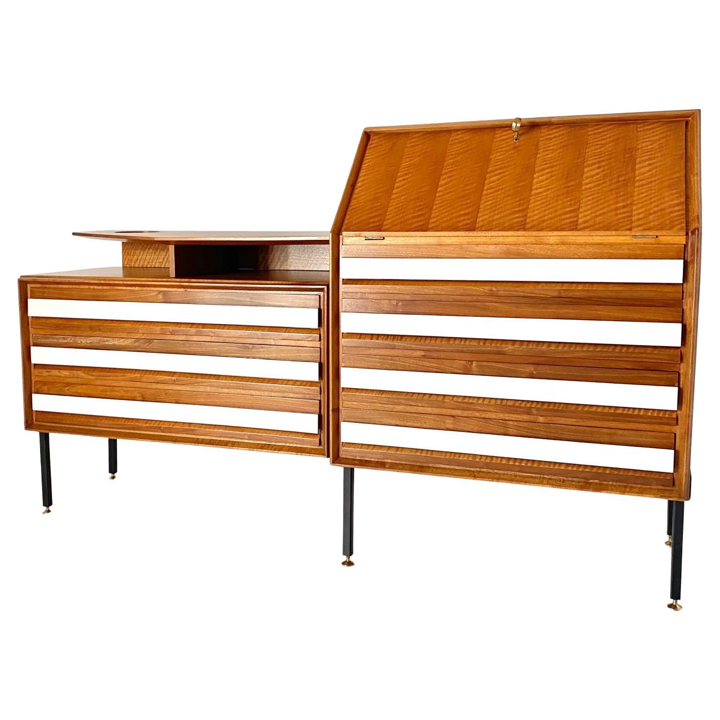 Design Sideboard with Drawers, Permanente Mobili Cantu

Crafted by Consorzio Mobili Cantù, Italy, in the 1960s, the piece features seven drawers made of solid walnut, each with a sleek white formica front, creating an eye-catching contrast between