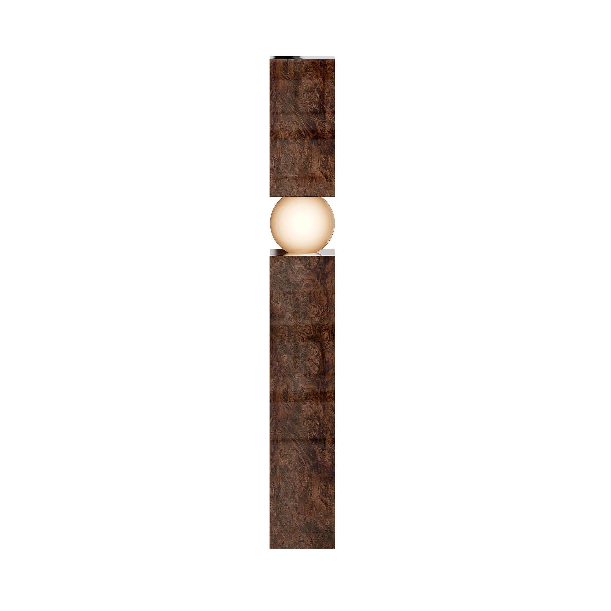 The Athena Floor Lamp Wood redefines minimal elegance, combining a dark wood base with clean architectural lines. Inspired by brutalist aesthetics, its structured form exudes quiet sophistication, offering a warm and tactile contrast to its sleek