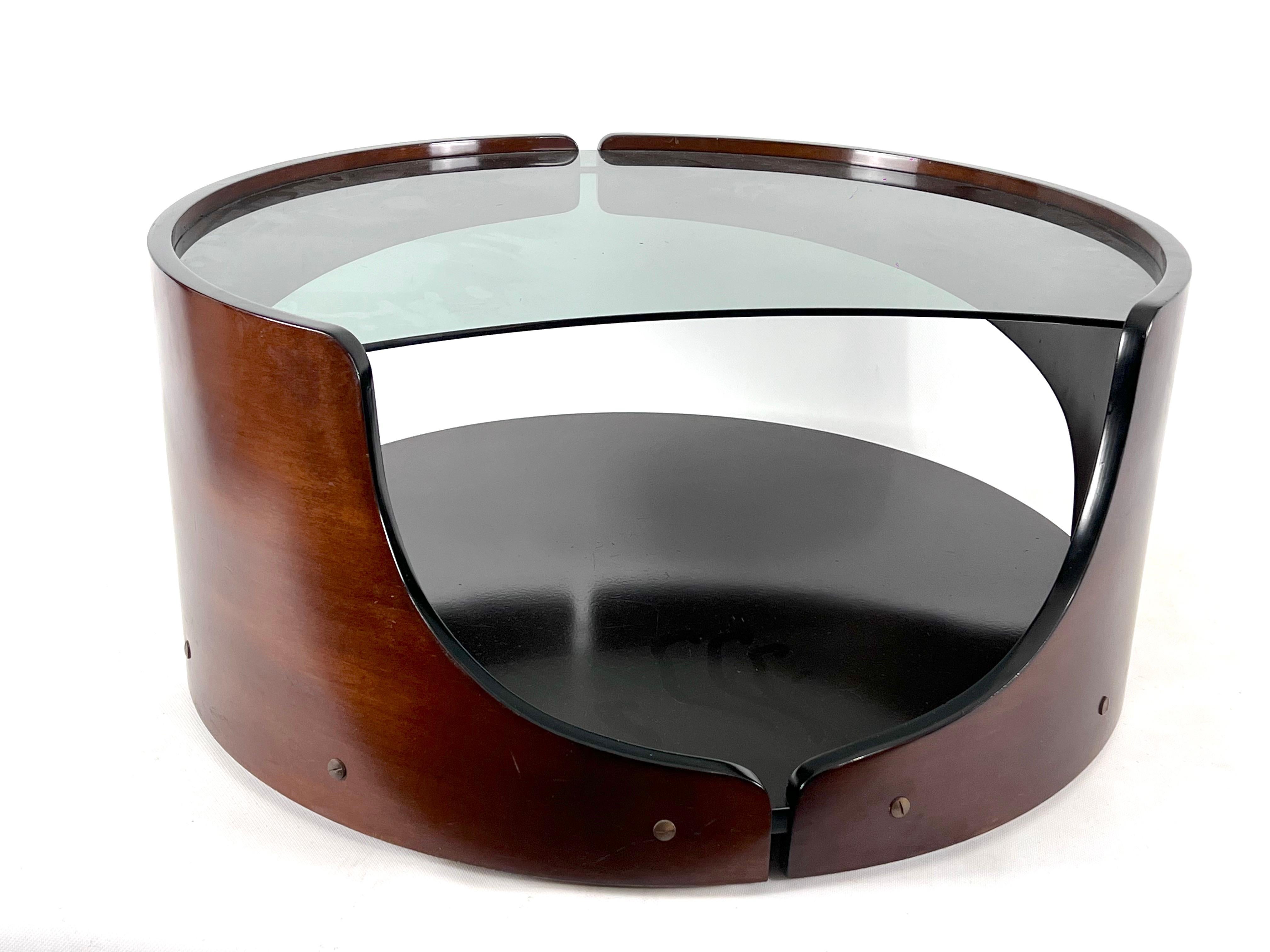 Great vintage condition with small trace of age and use for this round coffee table with wheels in the manner of Gio Colombo. Made from curved wood, smoked glass and metal details.
      