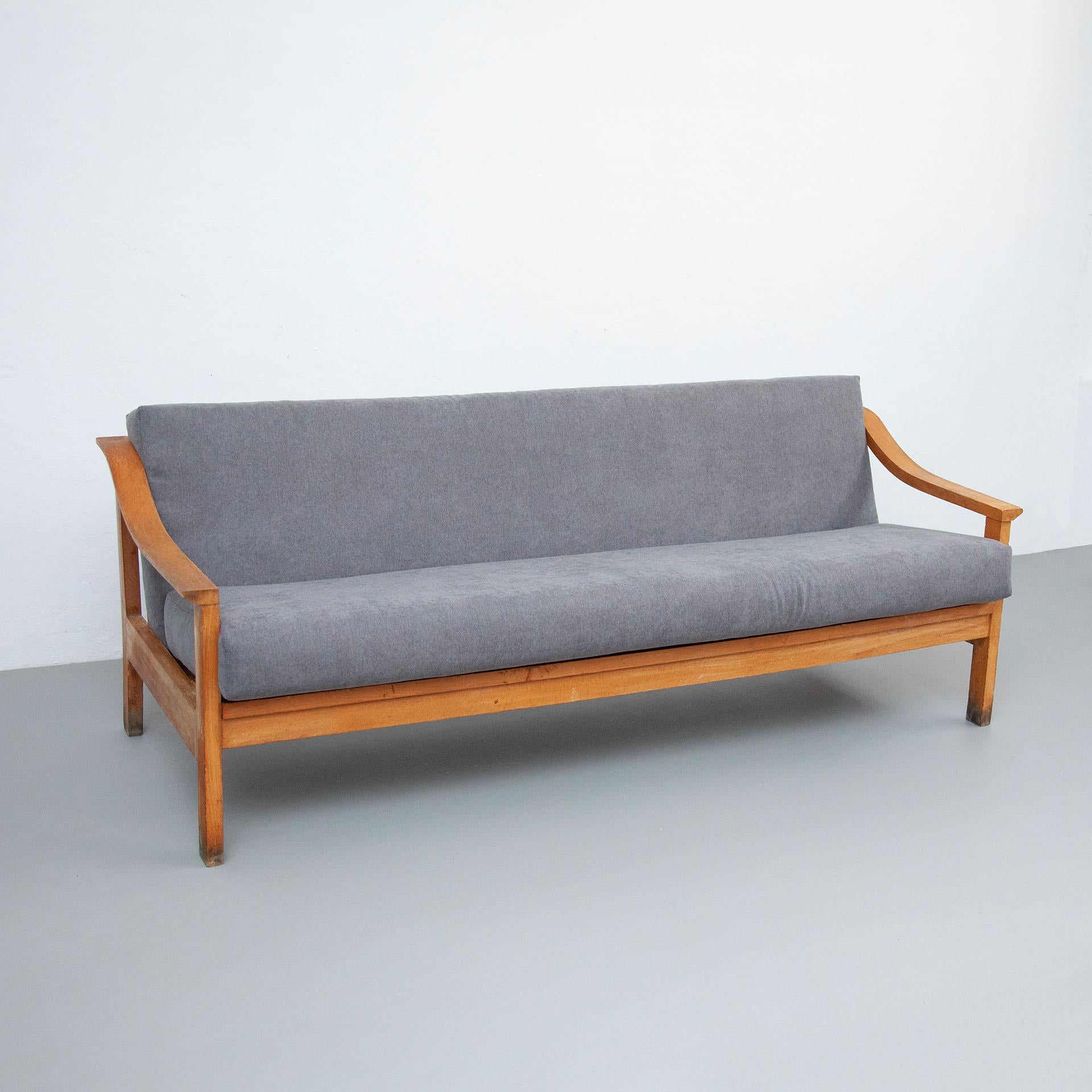 Mid-Century Modern wood Scandinavian sofa, circa 1950.
With a new upholstery.

In original condition, preserving a beautiful patina, with minor wear consistent with age and use. 

Materials:
Wood
Fabric

Dimensions:
D 71 cm x W 117 cm x H