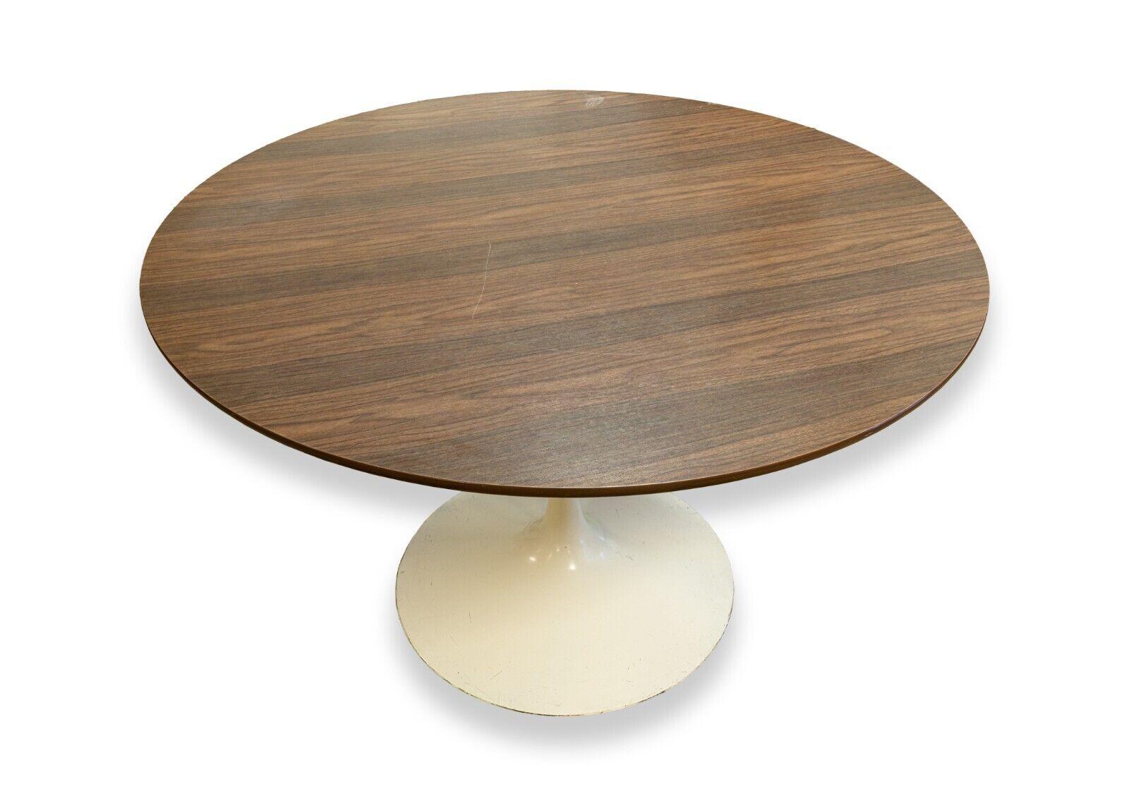A mid century modern wood top tulip base round dinette table. A wonderful little dinette table featuring a dark wood top and a white tulip style base. This table is in good condition. Both the table top and base are scratched and scuffed a bit, but