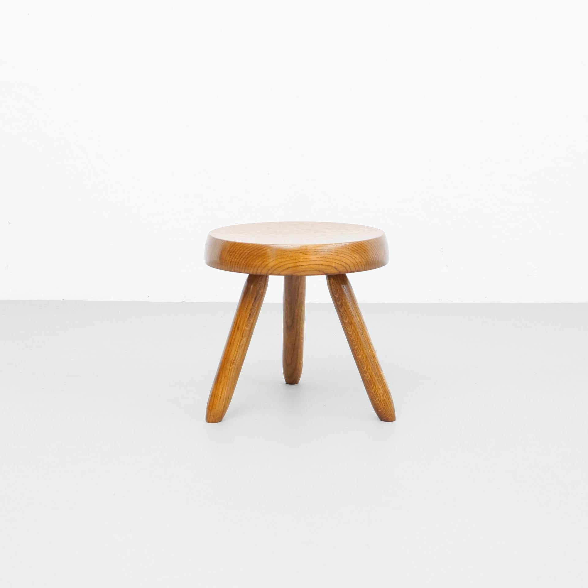 Stool designed in the style of Charlotte Perriand.
Made by unknown manufacturer.

In good original condition, preserving a beautiful patina, with minor wear consistent with age and use. 

Materials:
Wood

Dimensions:
ø 31 cm x H 30.5
