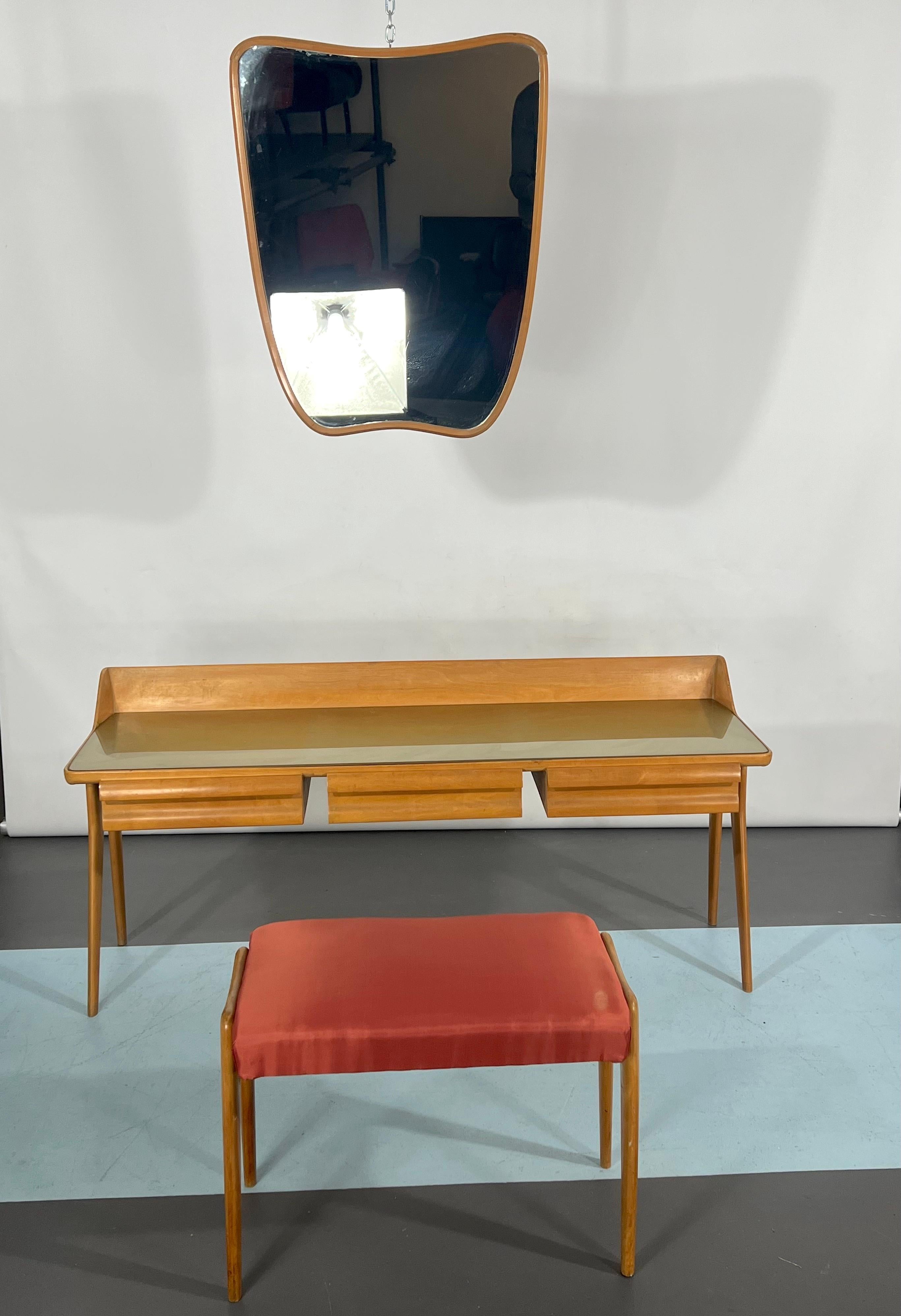 Great vintage condition for this vanity set composed of dressing table, stool and mirror. It is made from wood in bright finish. Reminiscent of Ico Parisi style and produced in Italy during the 1950s.