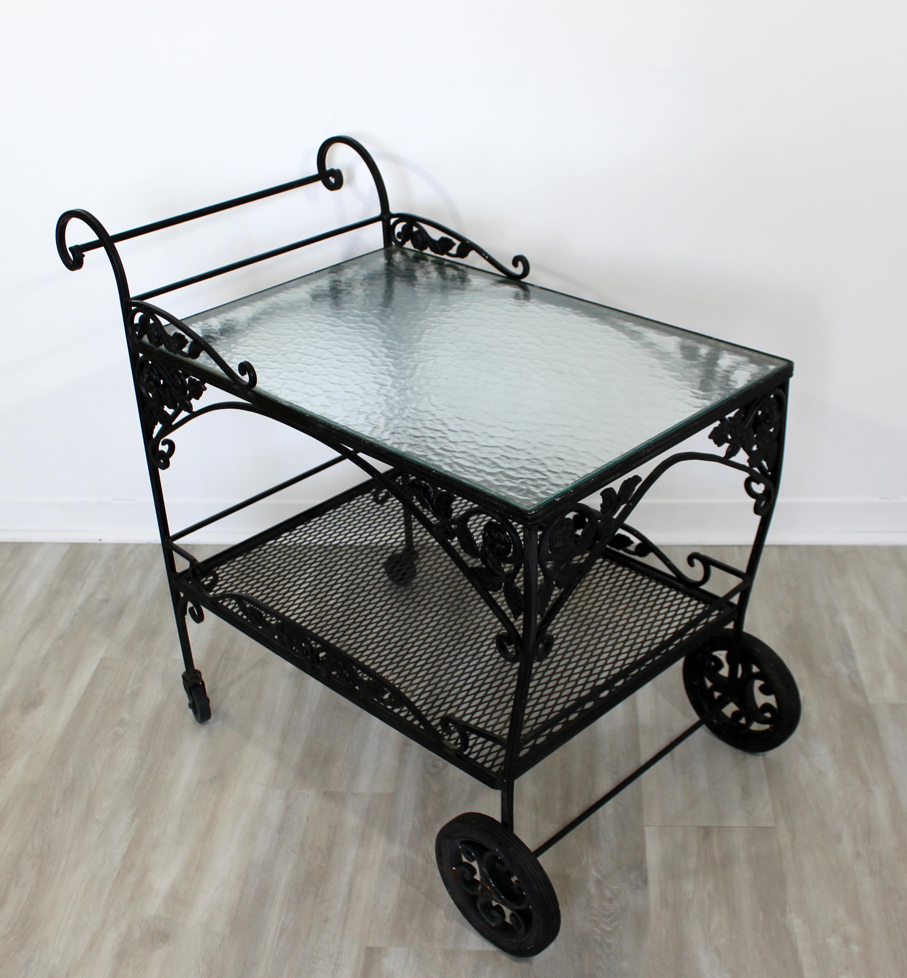 For your consideration is a stunning, wrought iron, patio bar or service cart, with a lovely floral pattern, and a glass top, circa 1960s. In very good vintage condition. The dimensions are 37