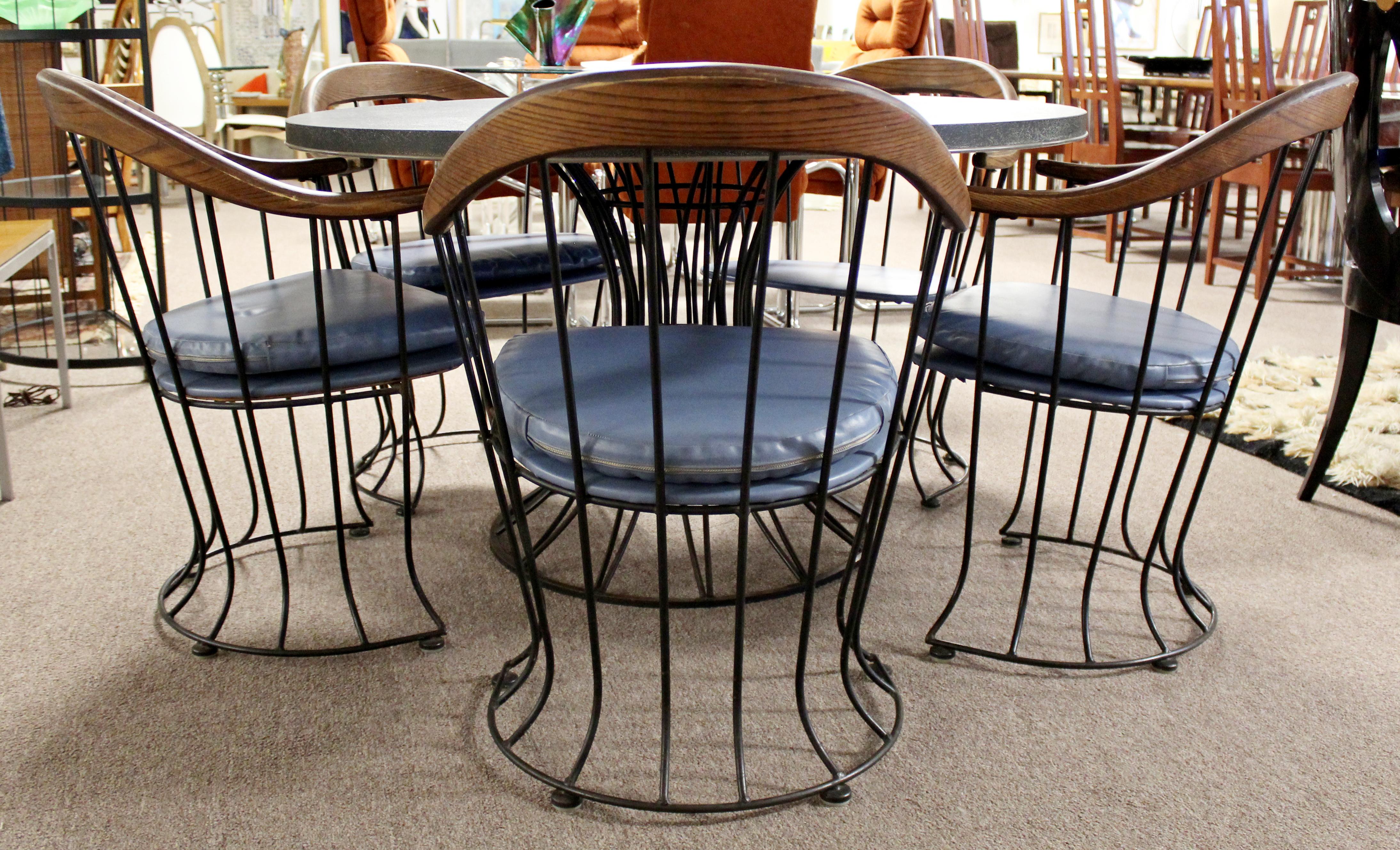 For your consideration is a brilliant, indoor/outdoor patio set of five, curved, wood topped armchairs and matching dining table with a slate top, by Russell Woodard, circa 1960s. In vintage condition. The dimensions of the chairs are 24