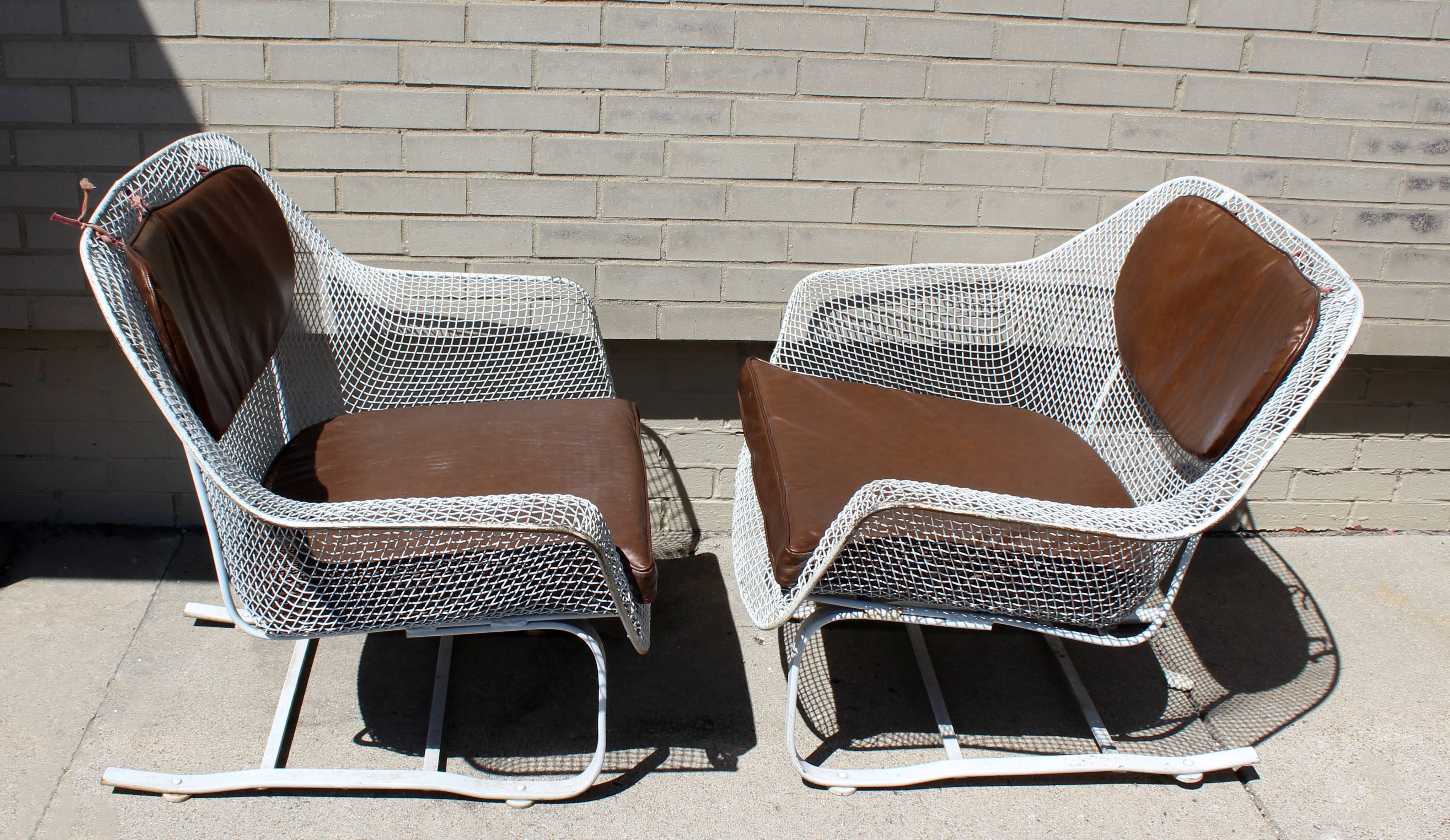 For your consideration is an amazing, white painted wrought iron, outdoor patio set by Woodard Sculptura, circa the 1950s. This large set includes a sofa, settee, pair of rockers, pair of armchairs and dinette set; and all come with their original,