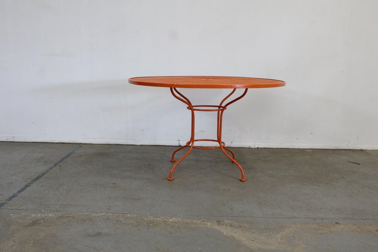 Mid-Century Modern atomic woodard sculptura table

Offered is a mid century Danish modern woodard atomic orange sculptura outdoor iron dining table designed by John Woodard, circa 1956 for the 'Sculptura' line. Features enameled and woven wrought