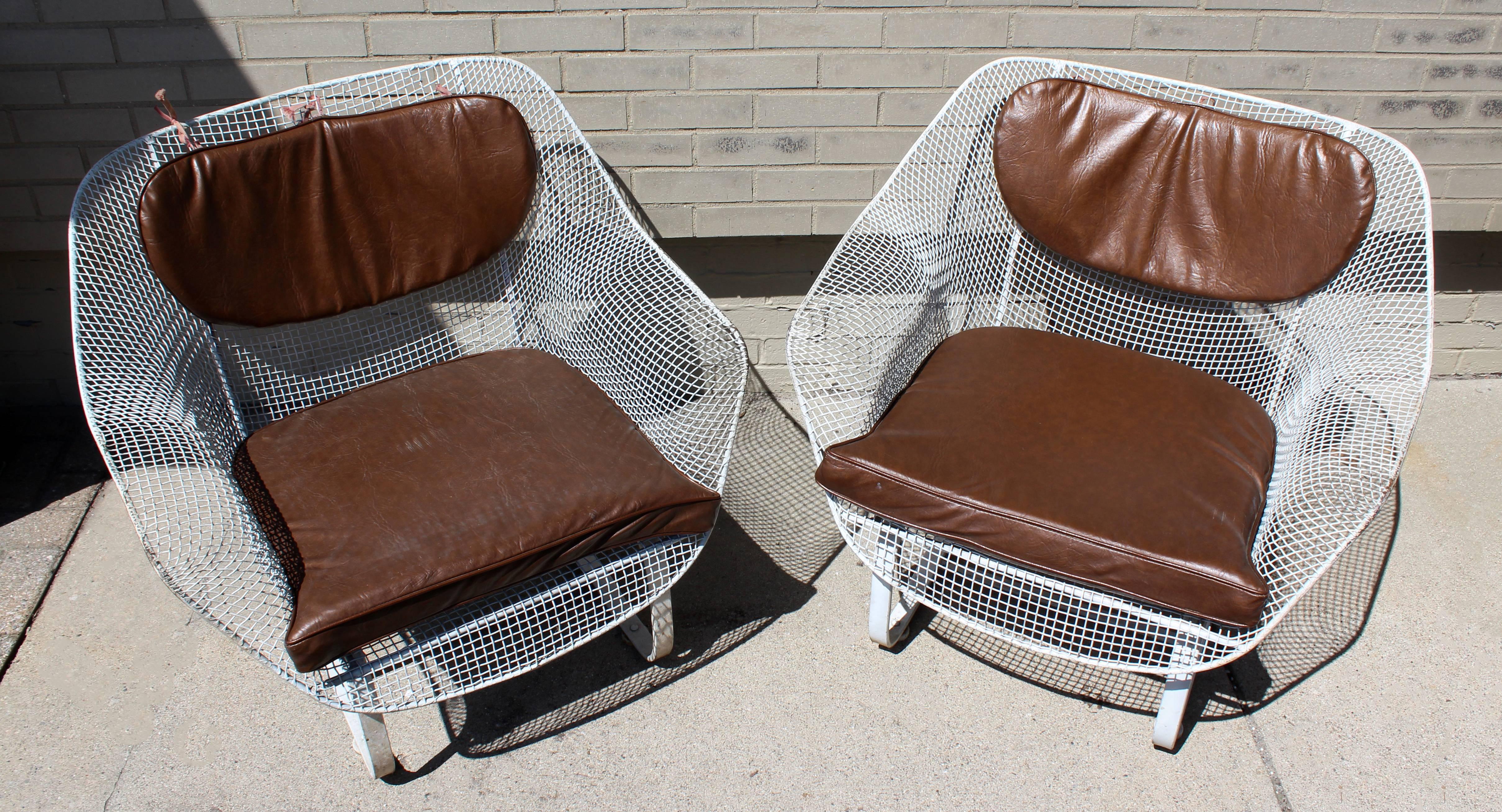 For your consideration is a fabulous pair of wrought iron, patio rocking chairs, with brown vinyl cushions by Woodard, circa the 1950s. In great condition. The dimensions are 33.25