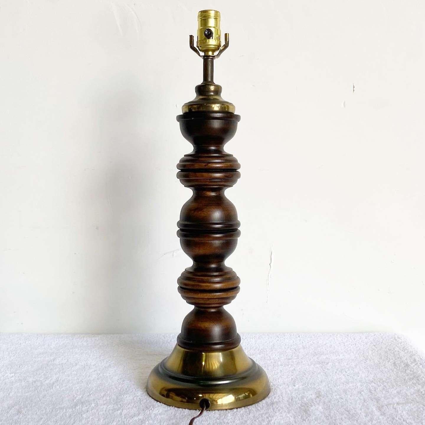 Wonderful vintage mid century modern pepper grinder table lamps. Features a sculpted wood body on a brass base.
