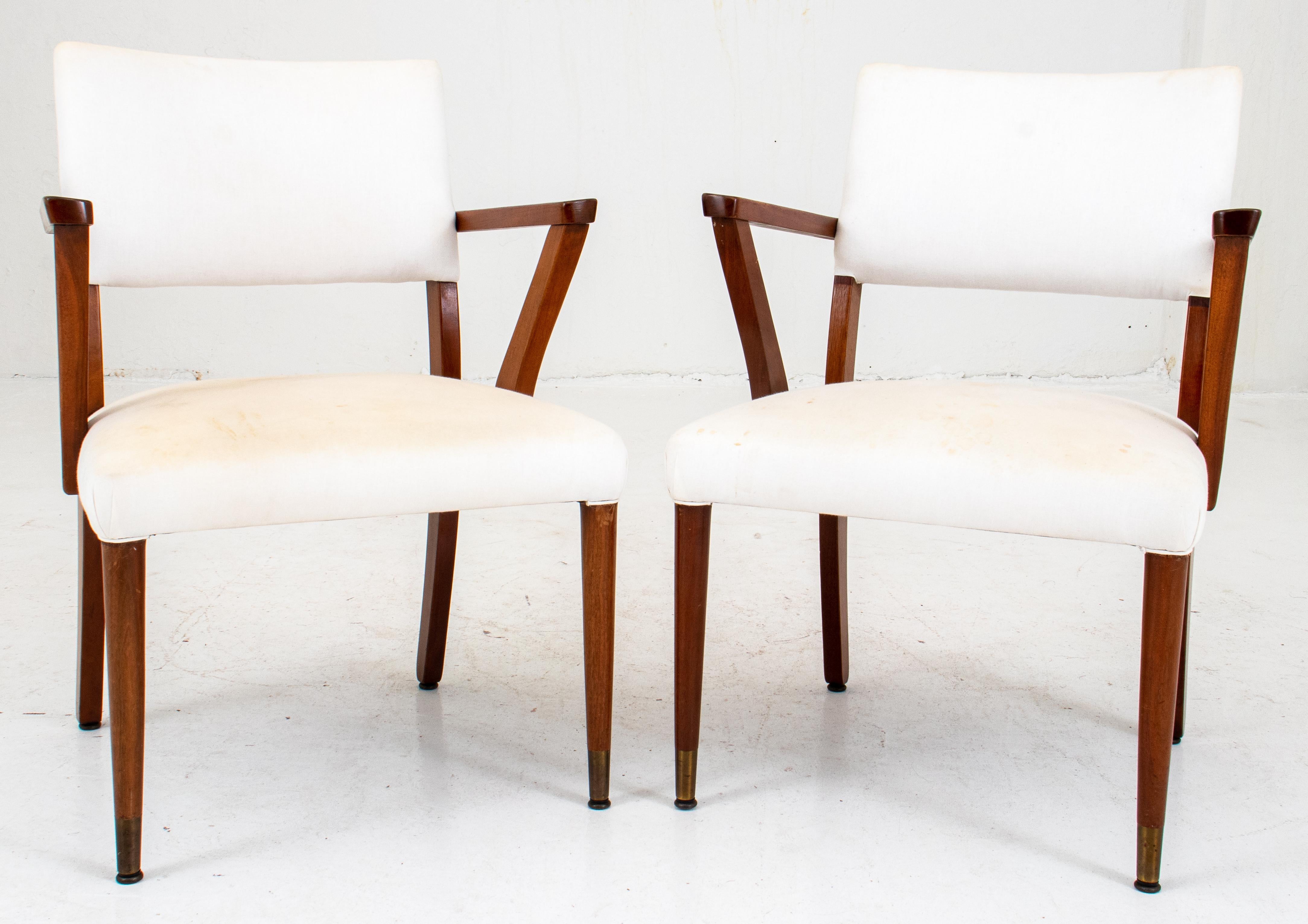 Pair of Mid-Century Modern hardwood armchairs with white cloth upholstery, front legs with brass feet. 33