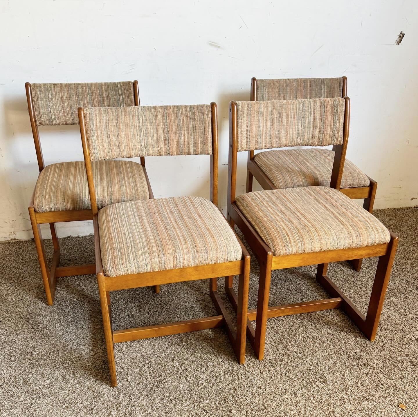 Discover the classic elegance of this set of 4 Mid Century Modern Wooden Chairs. Designed with clean lines and a timeless silhouette, these chairs offer durability and sophistication, making them ideal for various settings. Whether used in a dining