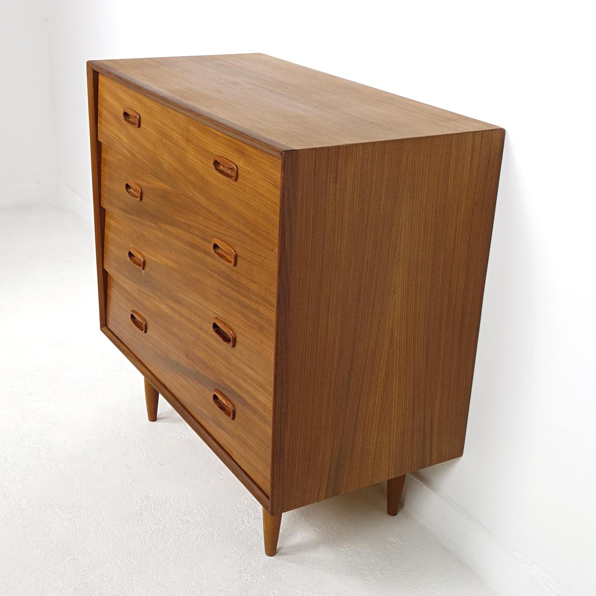 This midcentury chest of four drawers is attributed to Dutch designer Louis Van Teeffelen. The design is sleek and even simple, but there are some refined details, such as the grips and the legs.