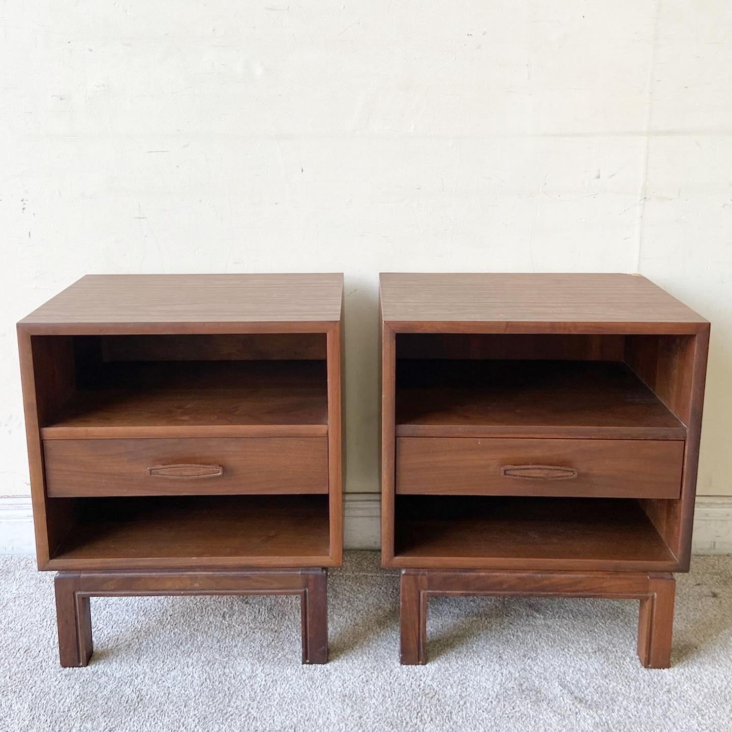 Phenomenal pair of mid century modern wooden nighstands. Each feature one drawer with an open shelf above and below the drawer. 