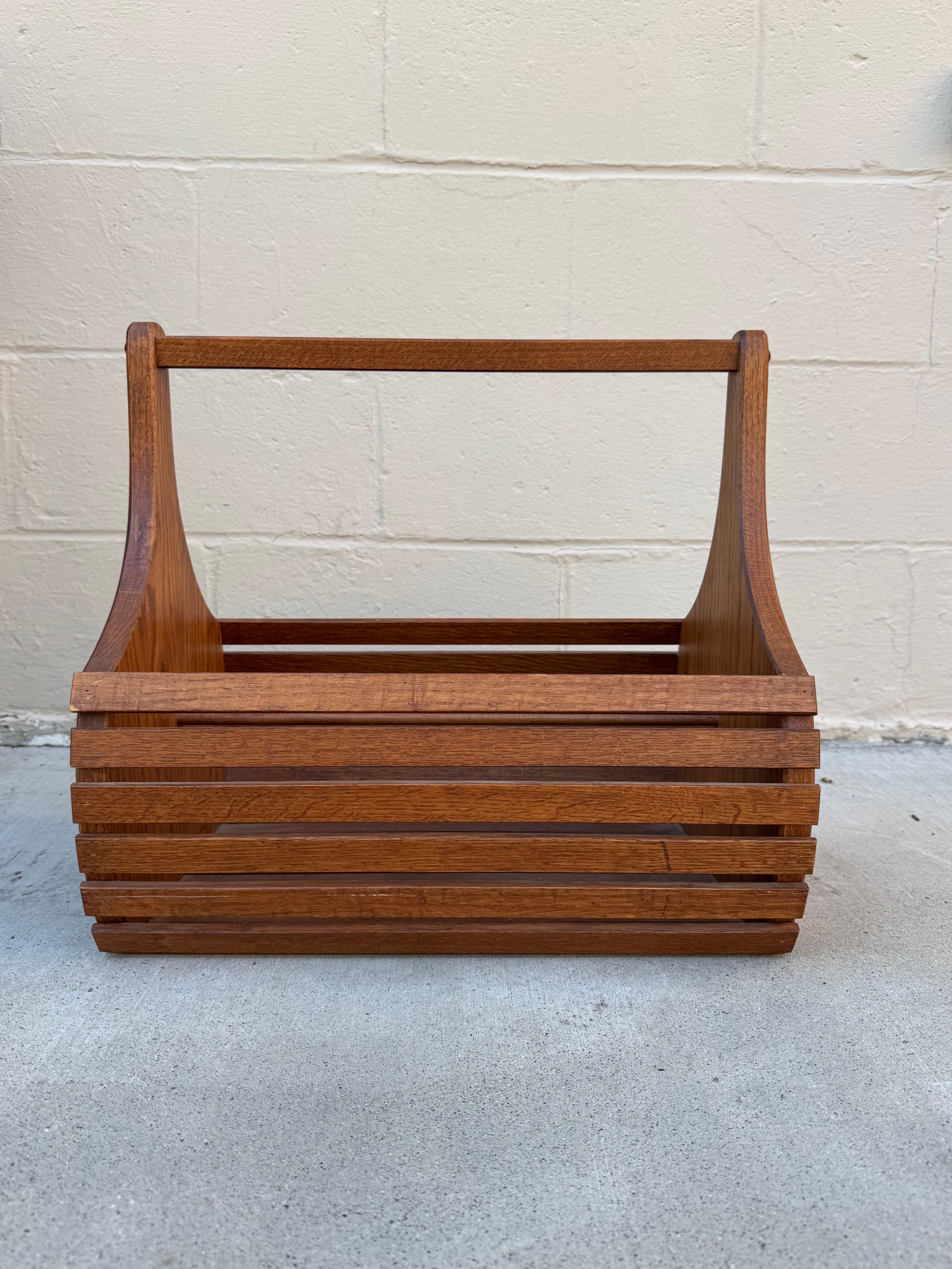 Mid-Century Modern Wooden Slatted Carry Basket, c. 1960s

Dimensions: 17.75ʺ L × 12ʺ W × 16.25ʺ H

Beautifully crafted mid-century modern wooden basket featuring clean lines, warm wood tones, and a sculptural silhouette. The open slatted design