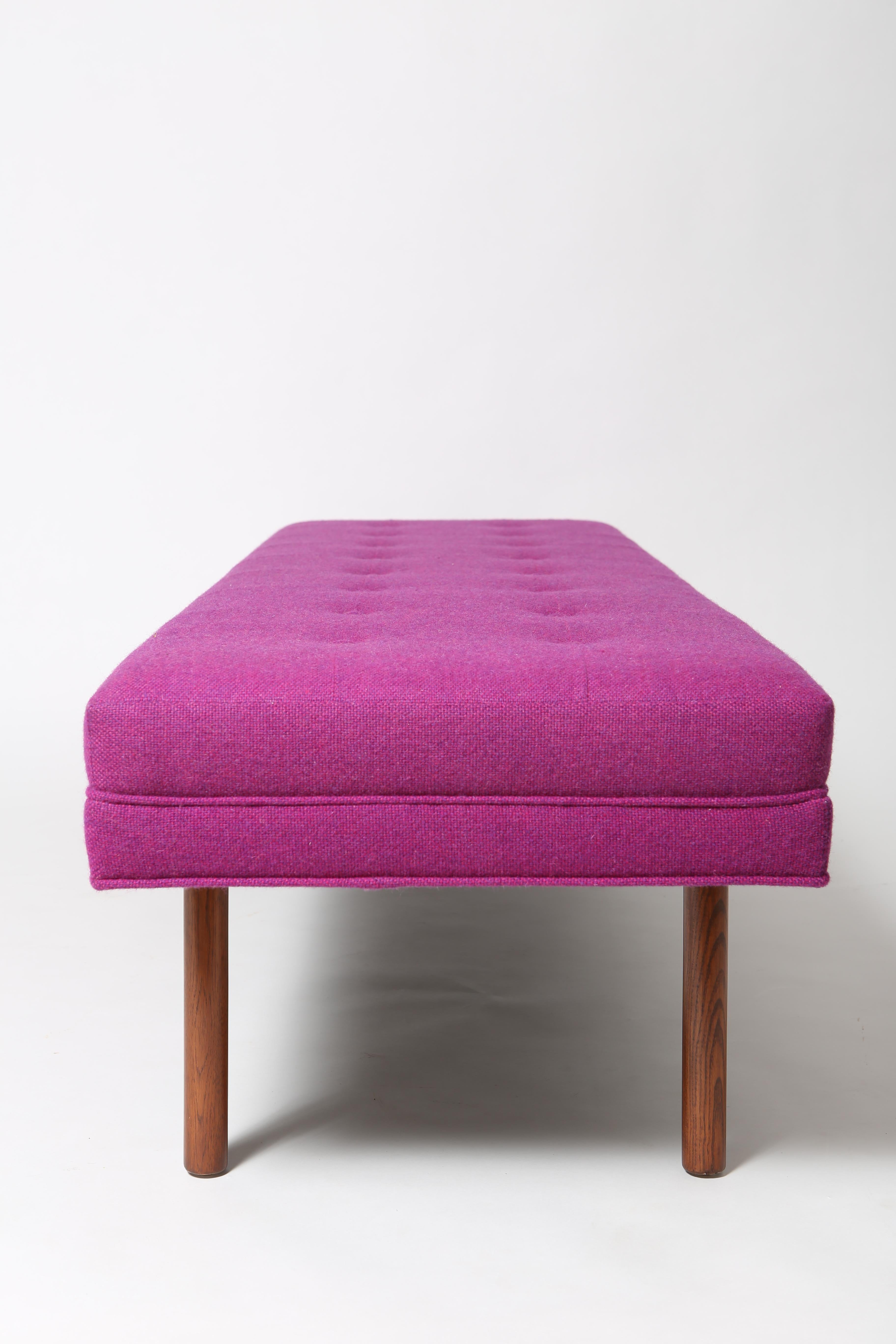 Gallery bench in vibrant purple wool. Grid-tufted and upholstered in a period-correct fabric, it has classic mid century lines. This bench has been completely expertly restored. We are unsure of the designer, but believe it’s American as this is an