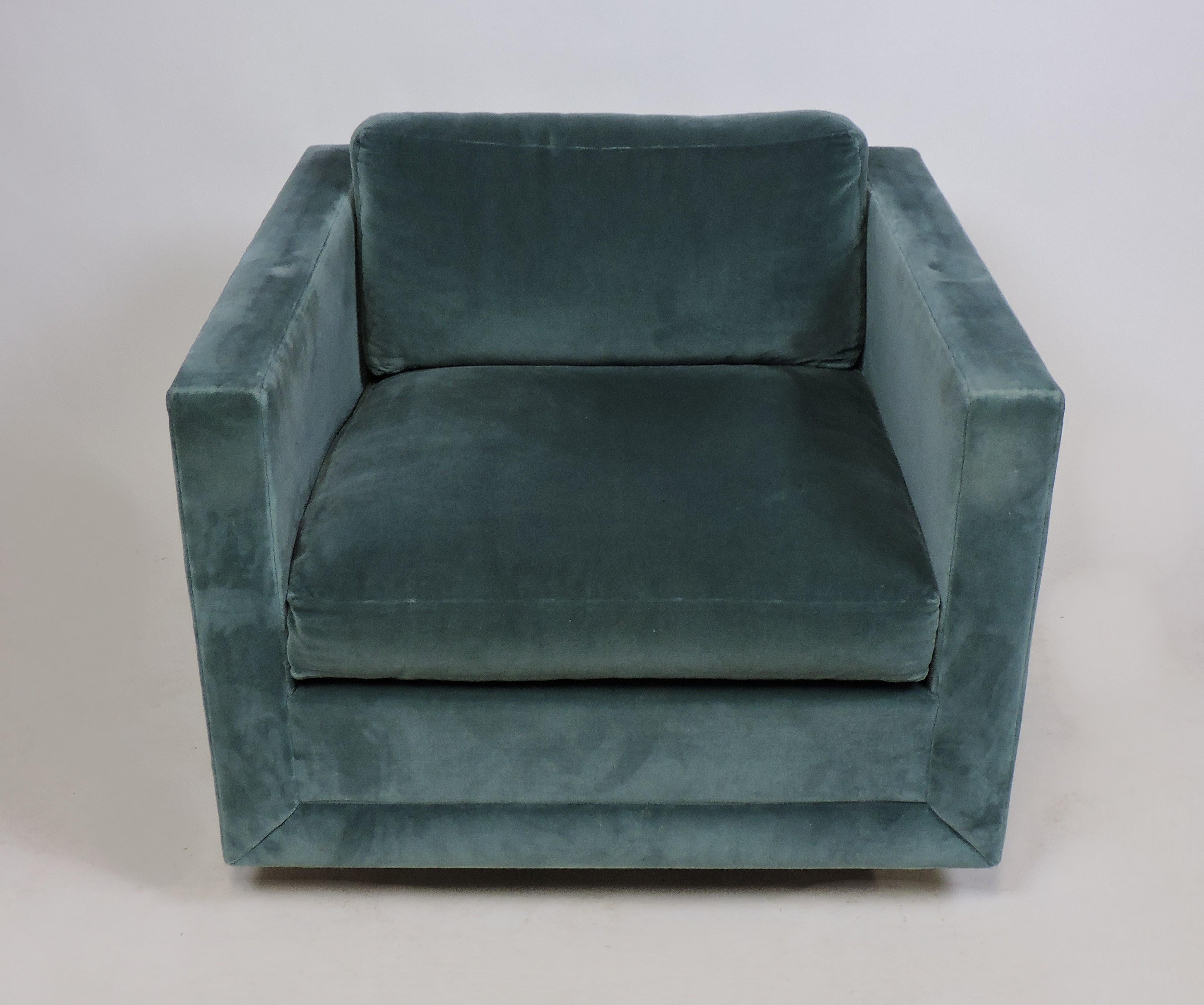 Beautiful and comfortable cube lounge chair in the style of Edward Wormley or Harvey Probber. This chair is upholstered in a teal color velvet and has three inch high wooden legs which give it a floating appearance. All of the cushions are zippered